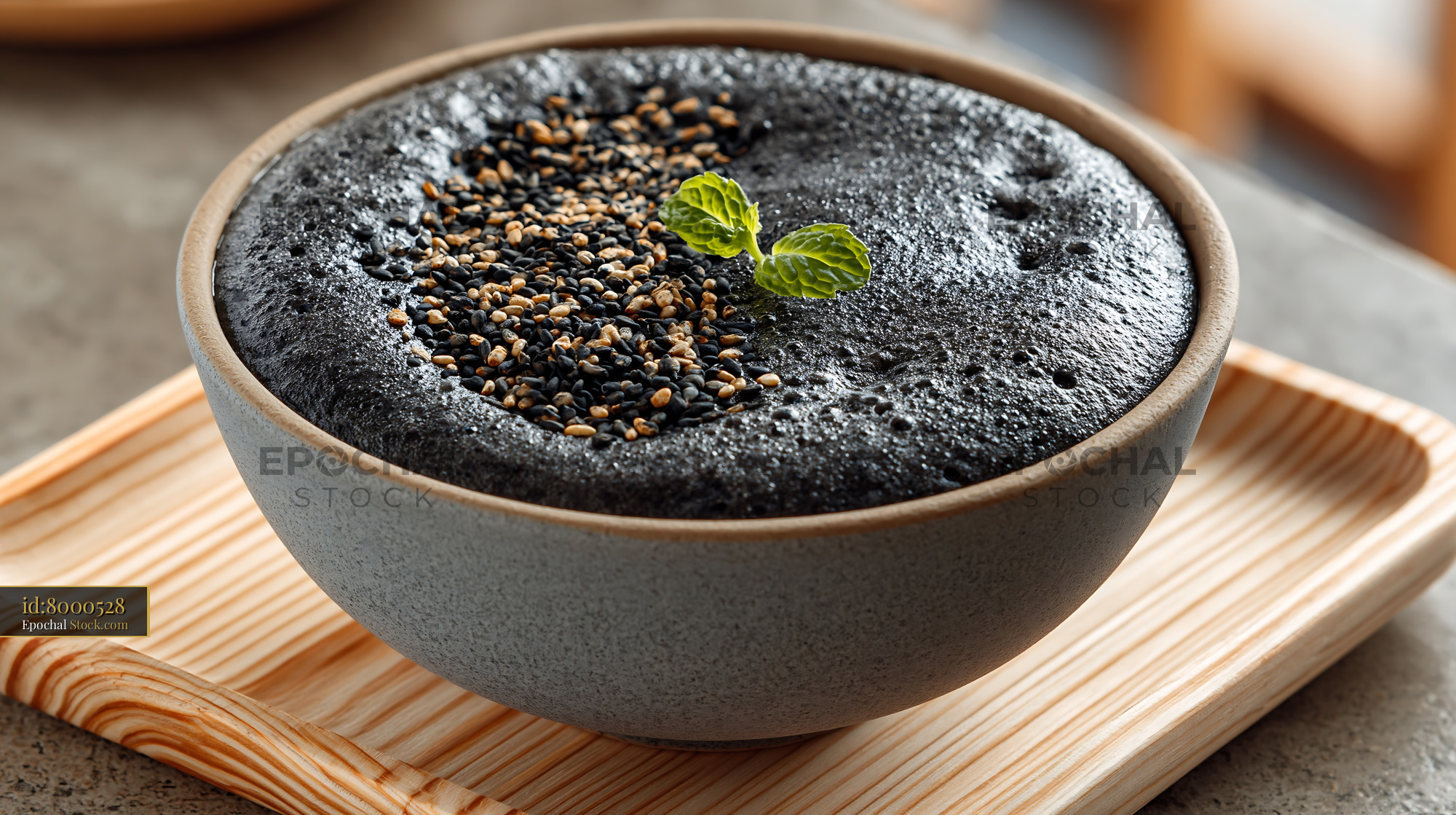 Kurogoma black sesame smoothie bowl with seeds and mint garnish - stock photo