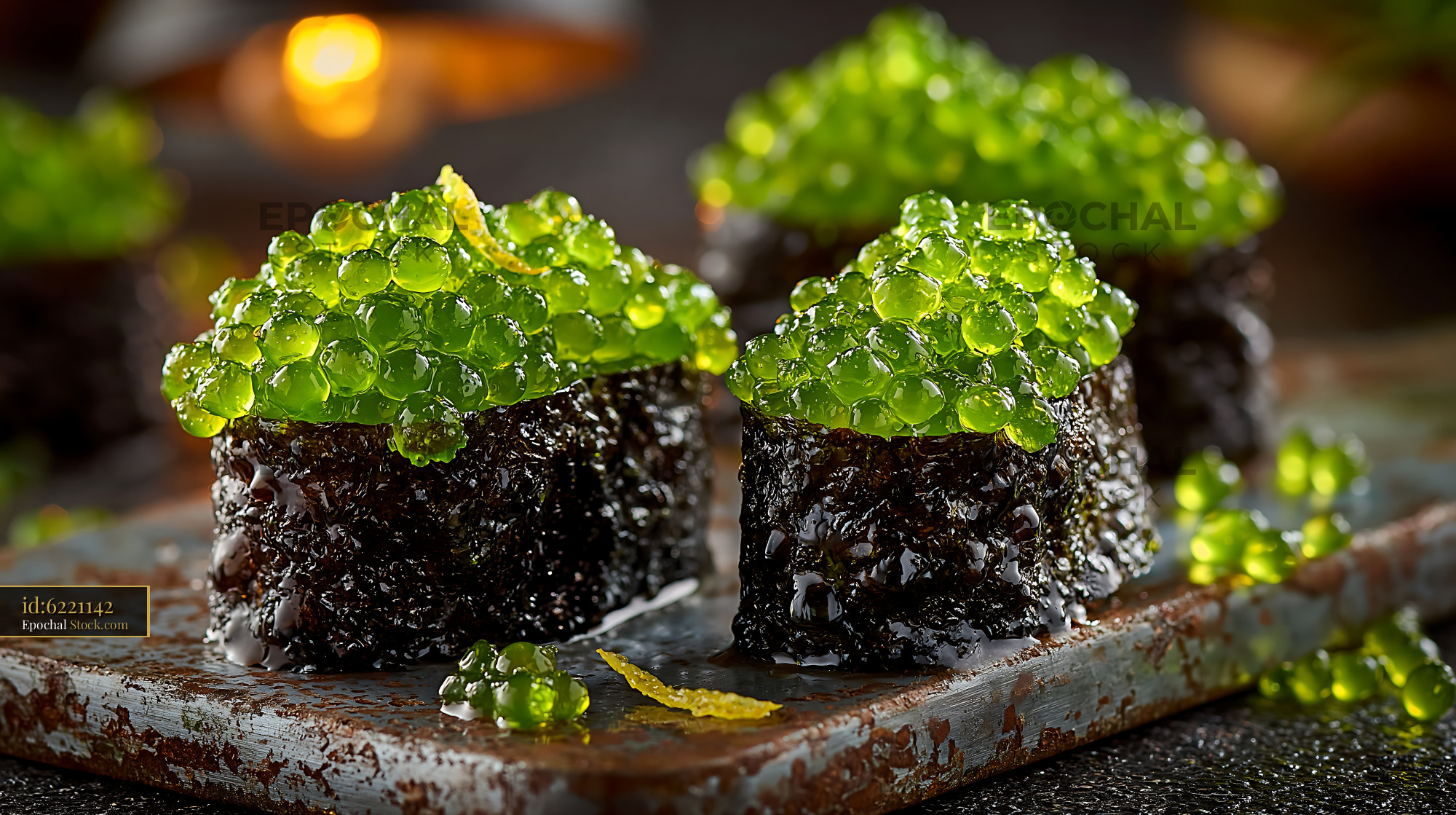 Umi budo sushi topped with fresh green sea grapes on a rustic platter - stock photo