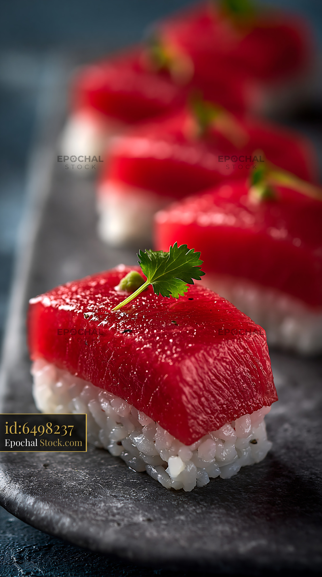 Gourmet watermelon tuna sushi served on a dark stone plate - stock photo