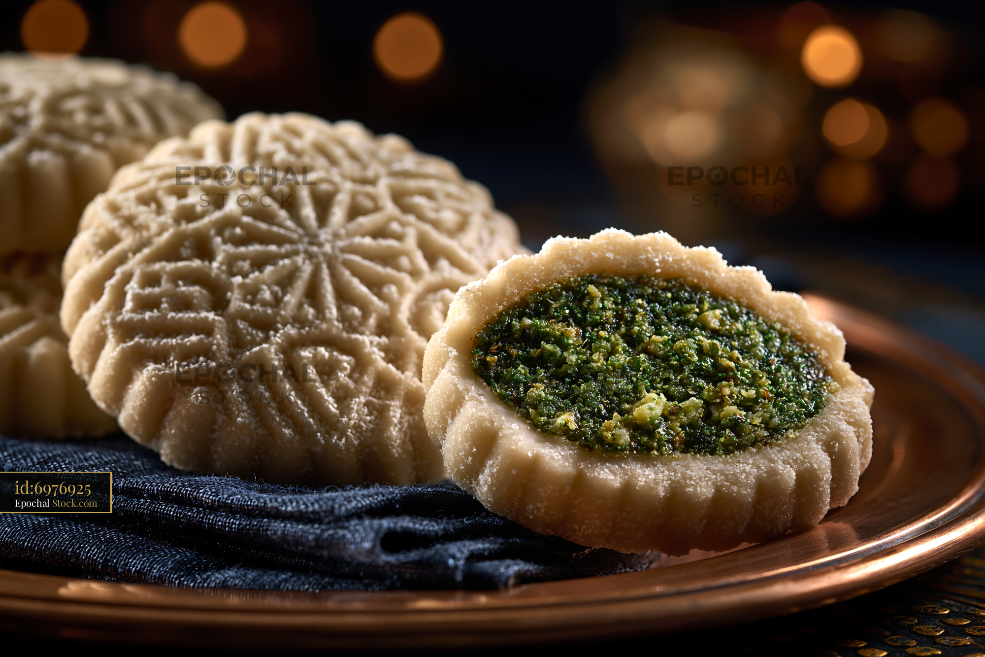 Traditional pistachio maamoul biscuits on a copper plate with bokeh li - stock photo
