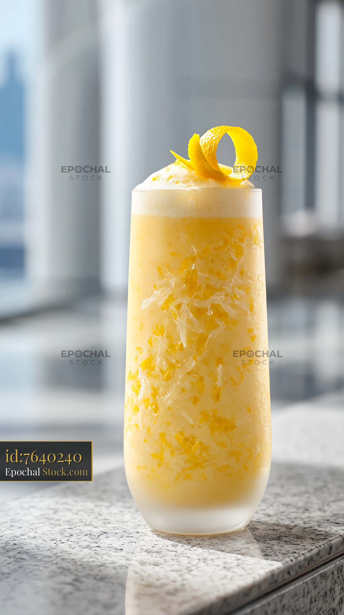 Yuja citron smoothie with citrus peel garnish on a granite counter - stock photo