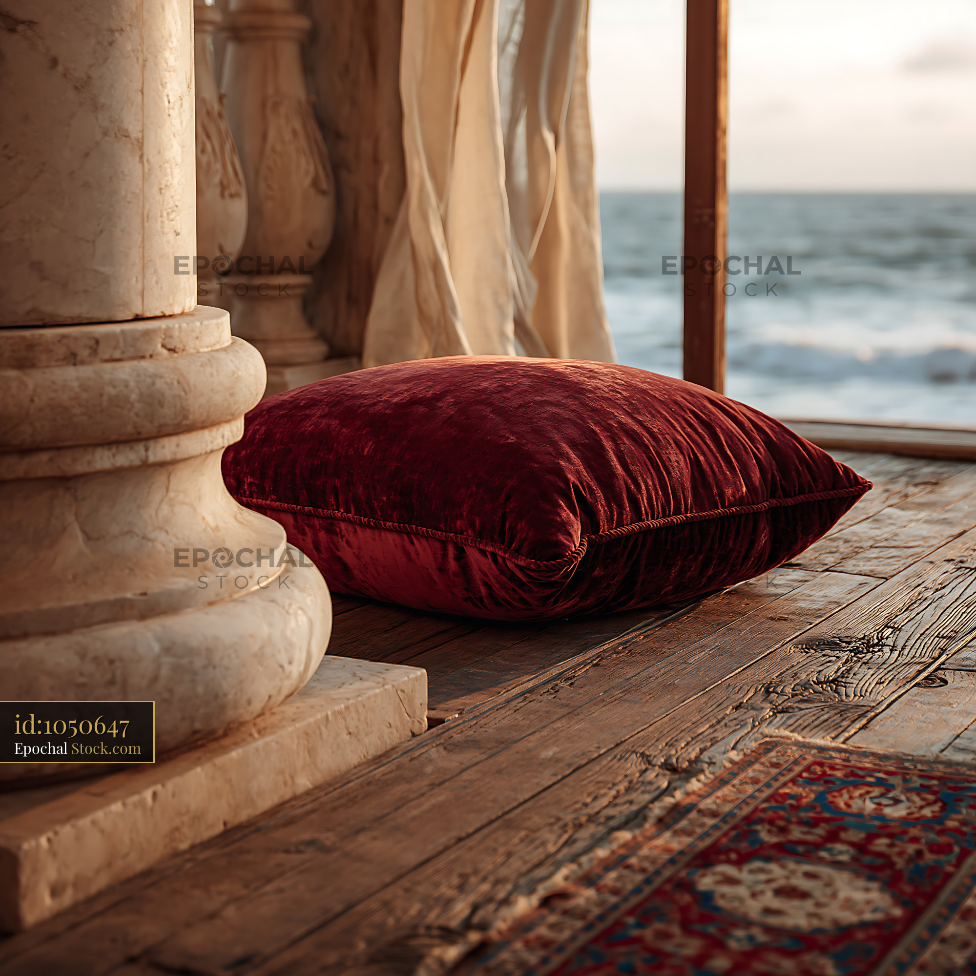 Red velvet cushion on a marble balcony with ocean view - stock photo