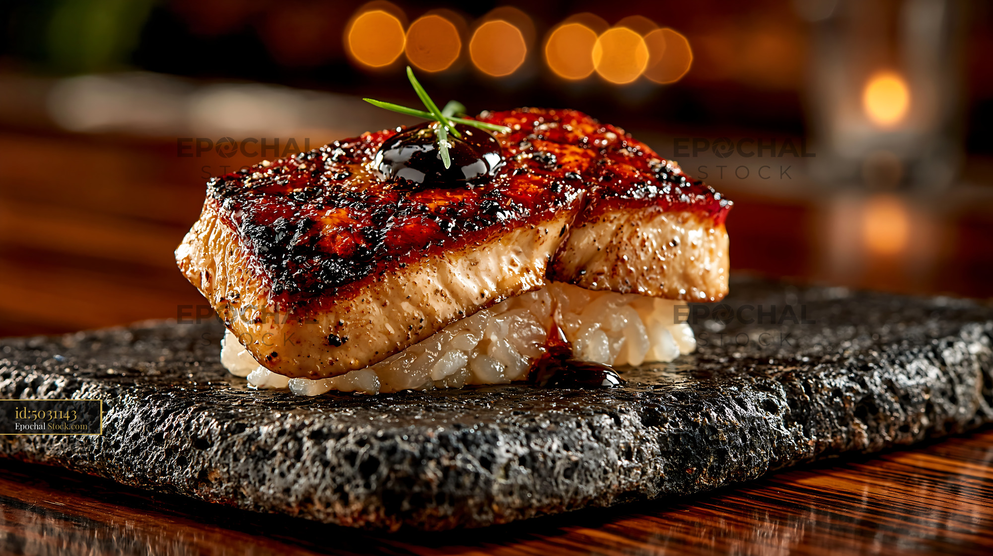 Seared foie gras nigiri sushi served on a dark stone plate - stock photo