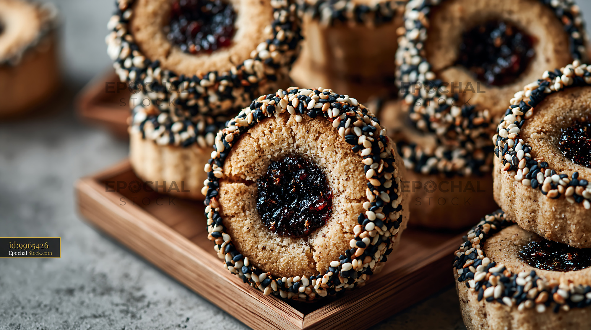 Homemade tahini date biscuits with sesame seeds on a wooden tray - stock photo
