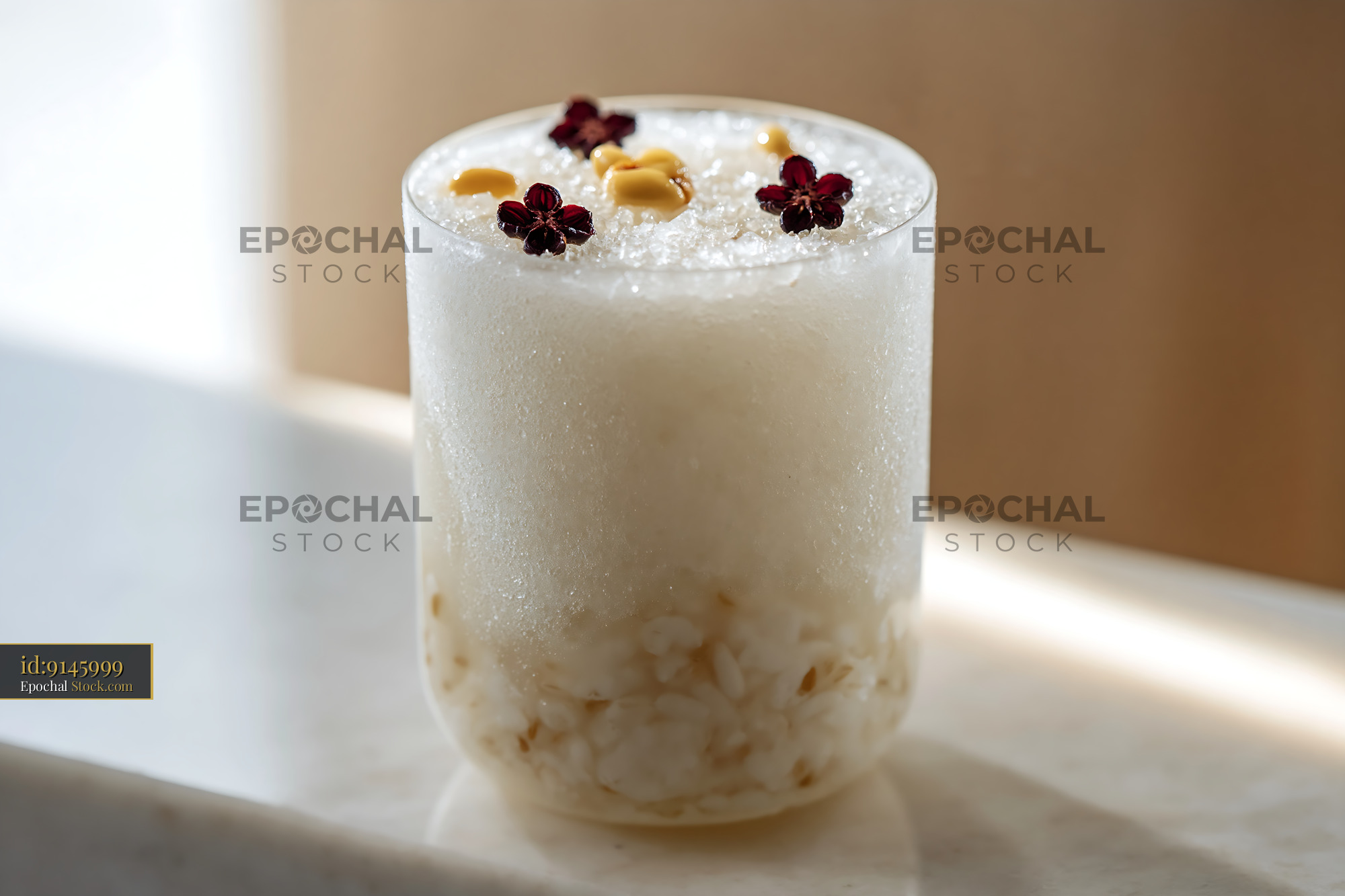 Refreshing Korean sikhye rice smoothie garnished with pine nuts - stock photo