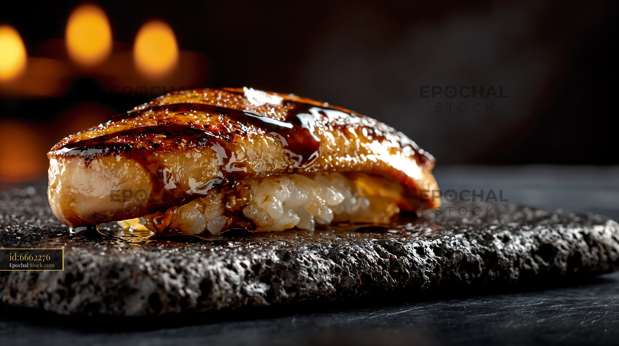 Foie gras nigiri sushi with dark glaze on black stone plate - stock photo