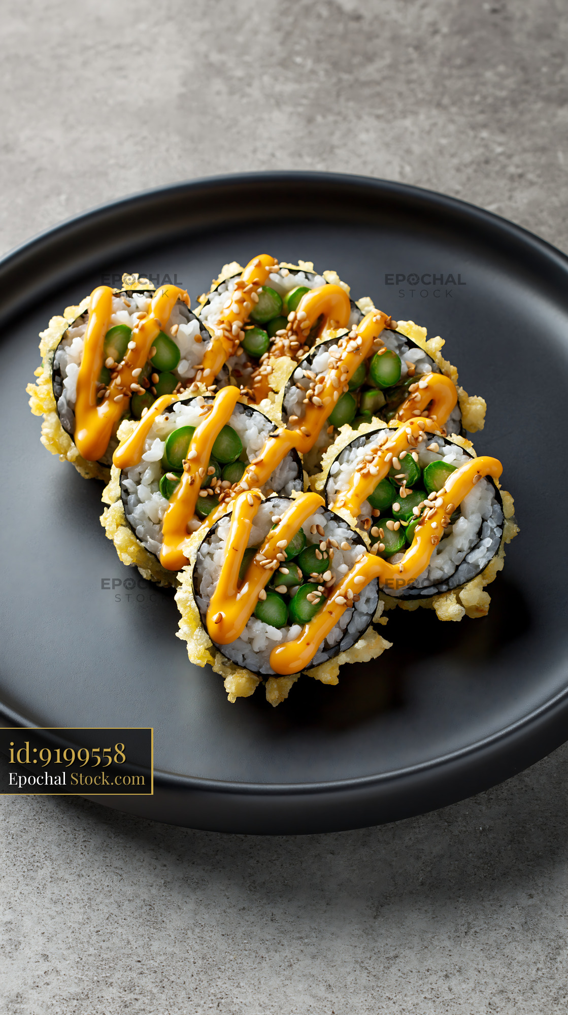Crispy tempura asparagus sushi rolls drizzled with spicy mayo - stock photo
