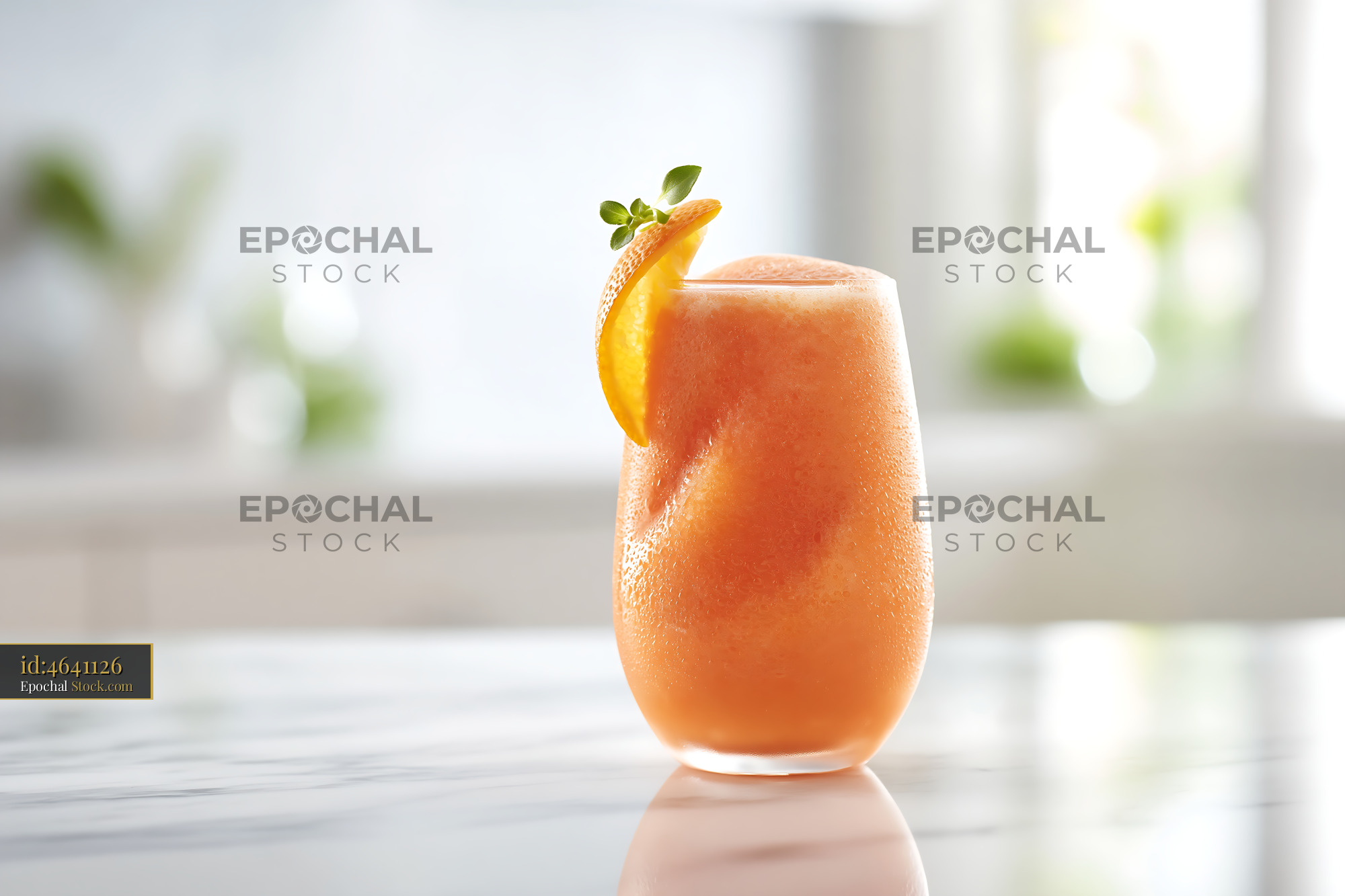 Mikan orange smoothie garnished with citrus on a marble counter - stock photo