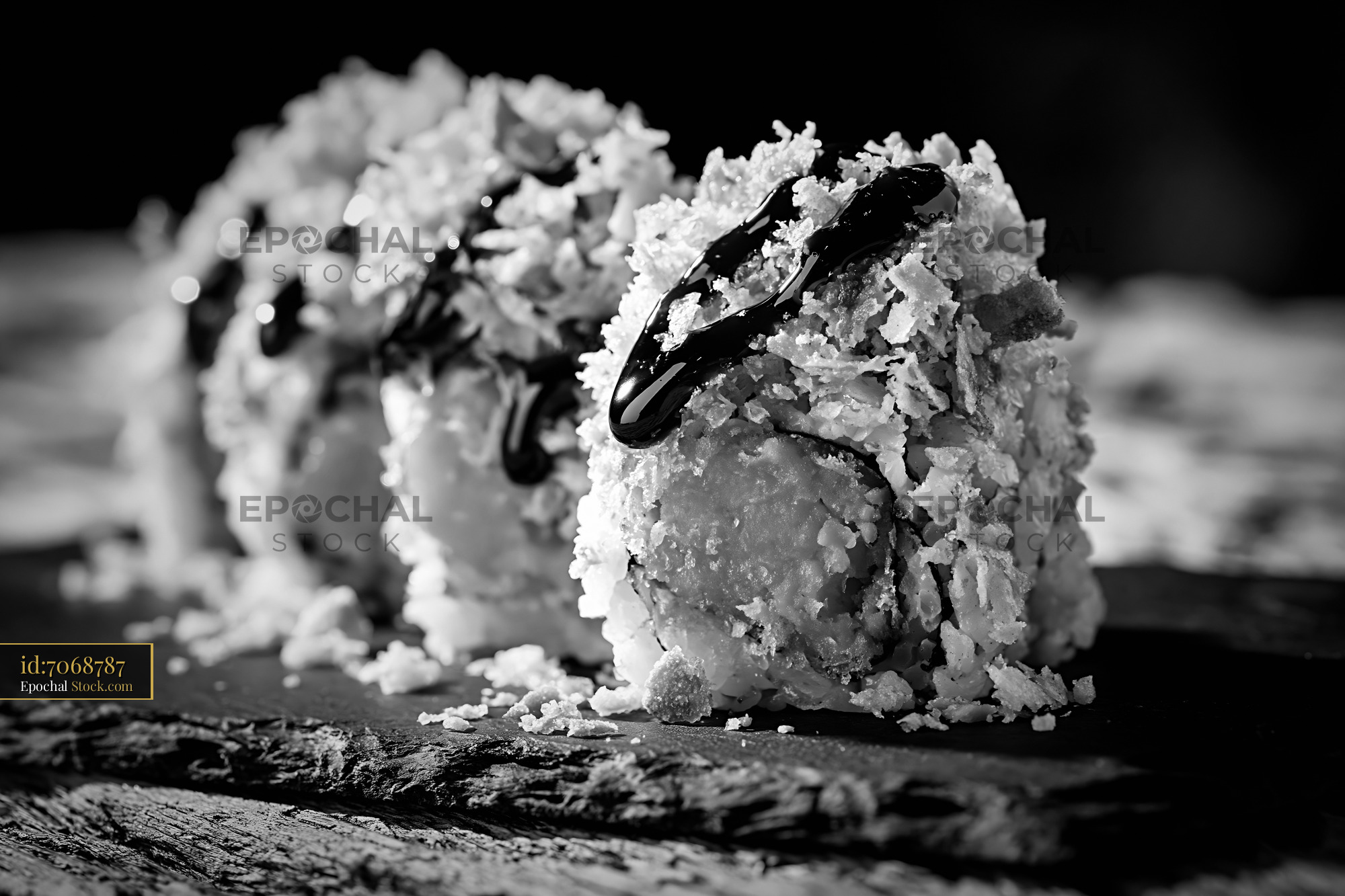 Sweet potato crunch sushi rolls with dark sauce on slate board - stock photo
