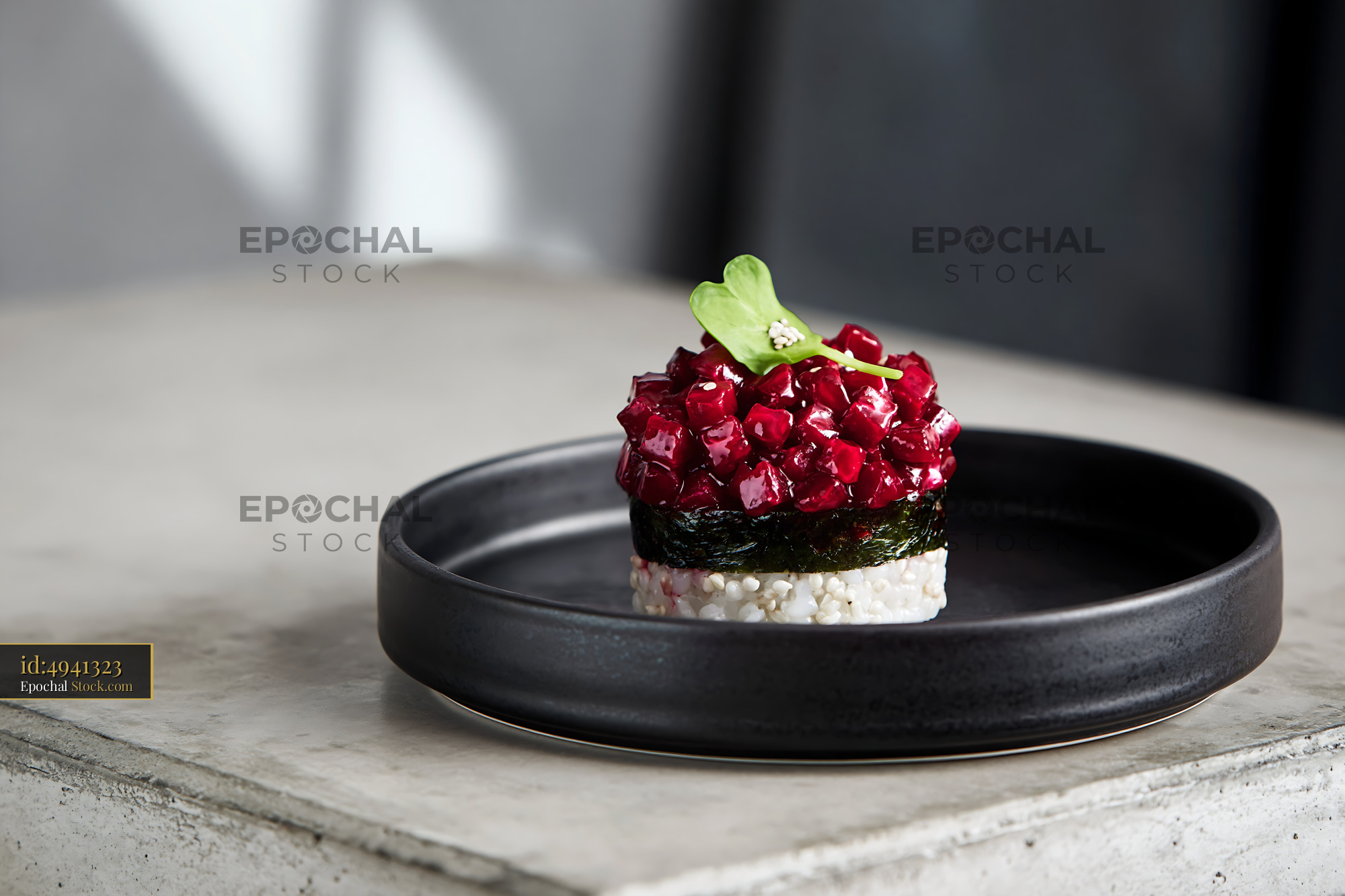 Vegan beet tartare sushi stack with nori and rice on a black plate - stock photo