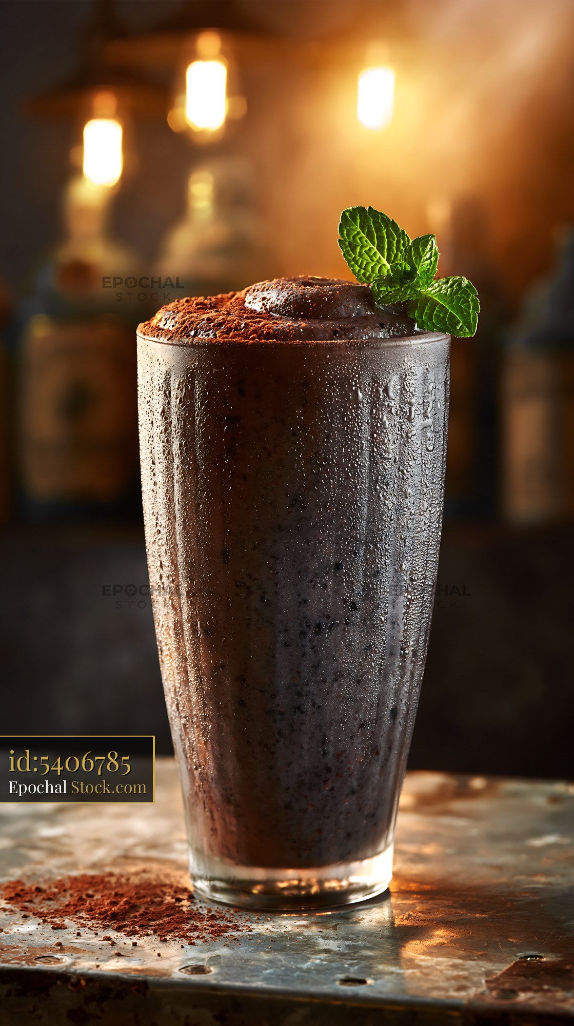 Chilled black bean smoothie topped with cocoa powder and fresh mint - stock photo