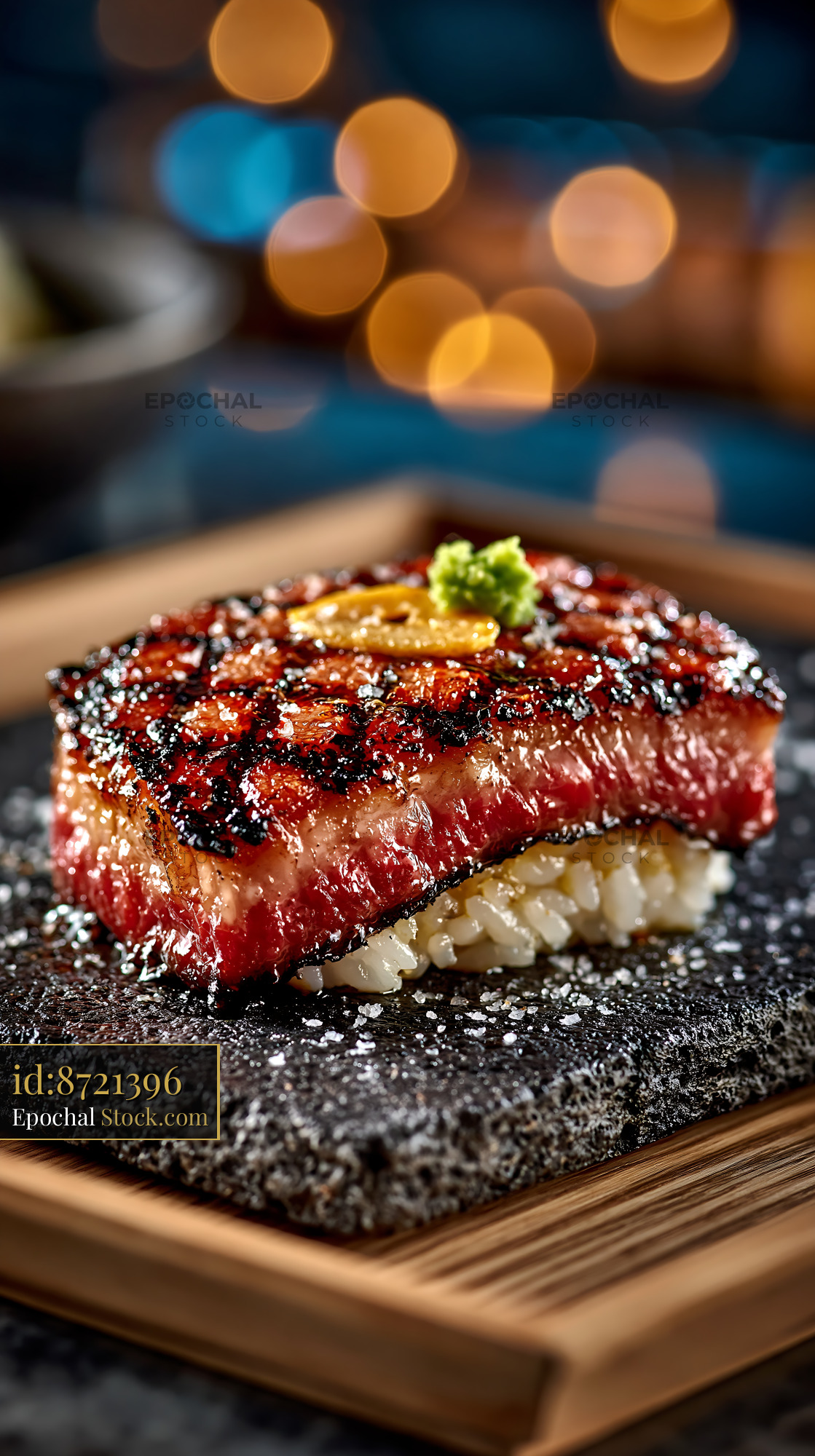 Aburi wagyu sushi topped with garlic and wasabi on a stone plate - stock photo