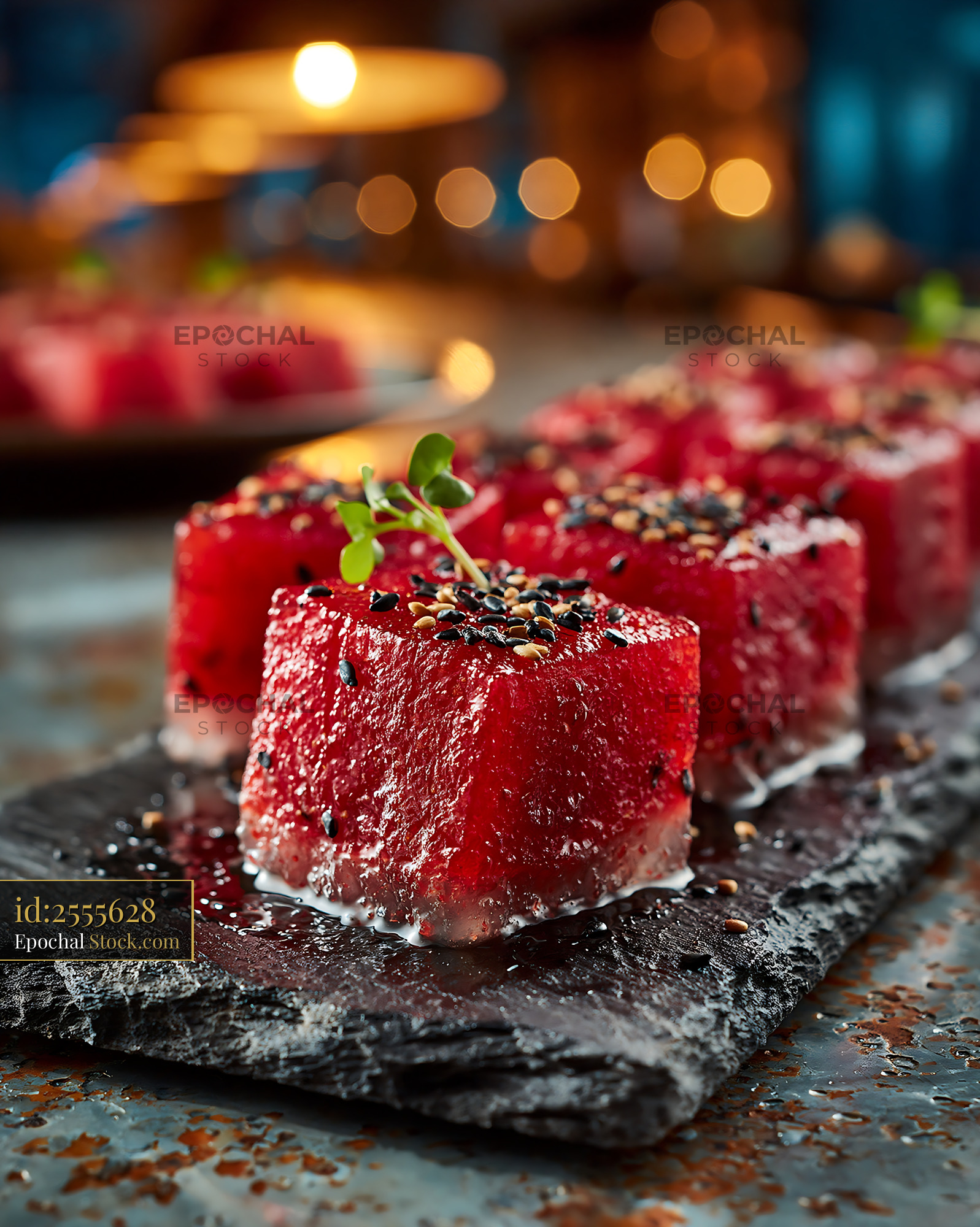 Vegan watermelon tuna sushi with sesame seeds in a moody restaurant - stock photo