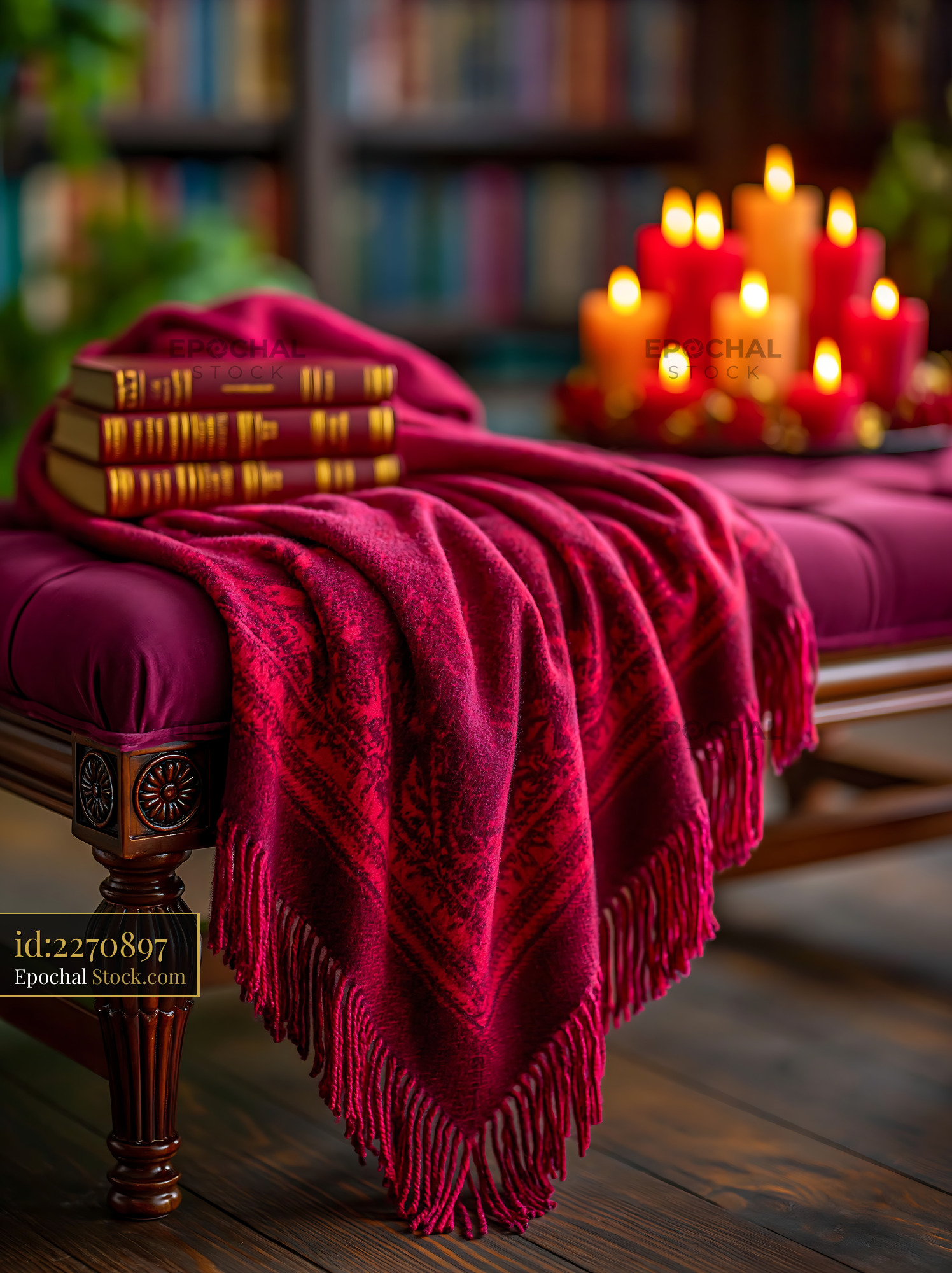 Cashmere throw on bench with books and candles in cozy library - stock photo