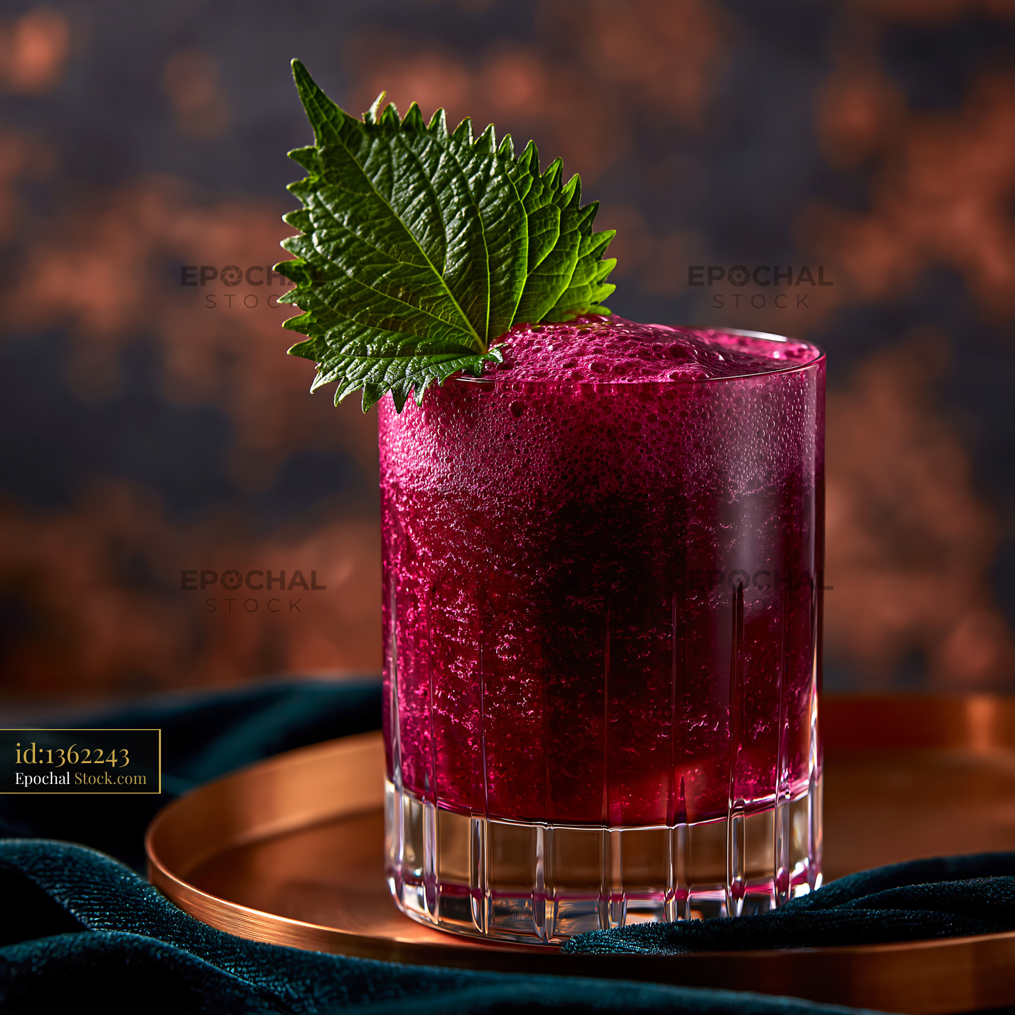 Vibrant shiso leaf smoothie in a crystal glass on a copper tray - stock photo
