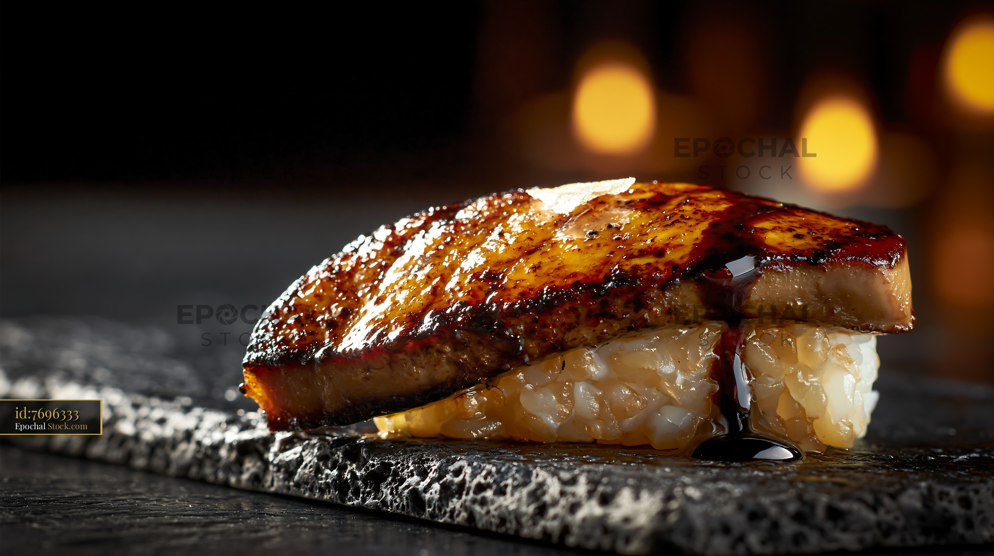 Foie gras nigiri sushi with dark glaze on a black stone plate - stock photo