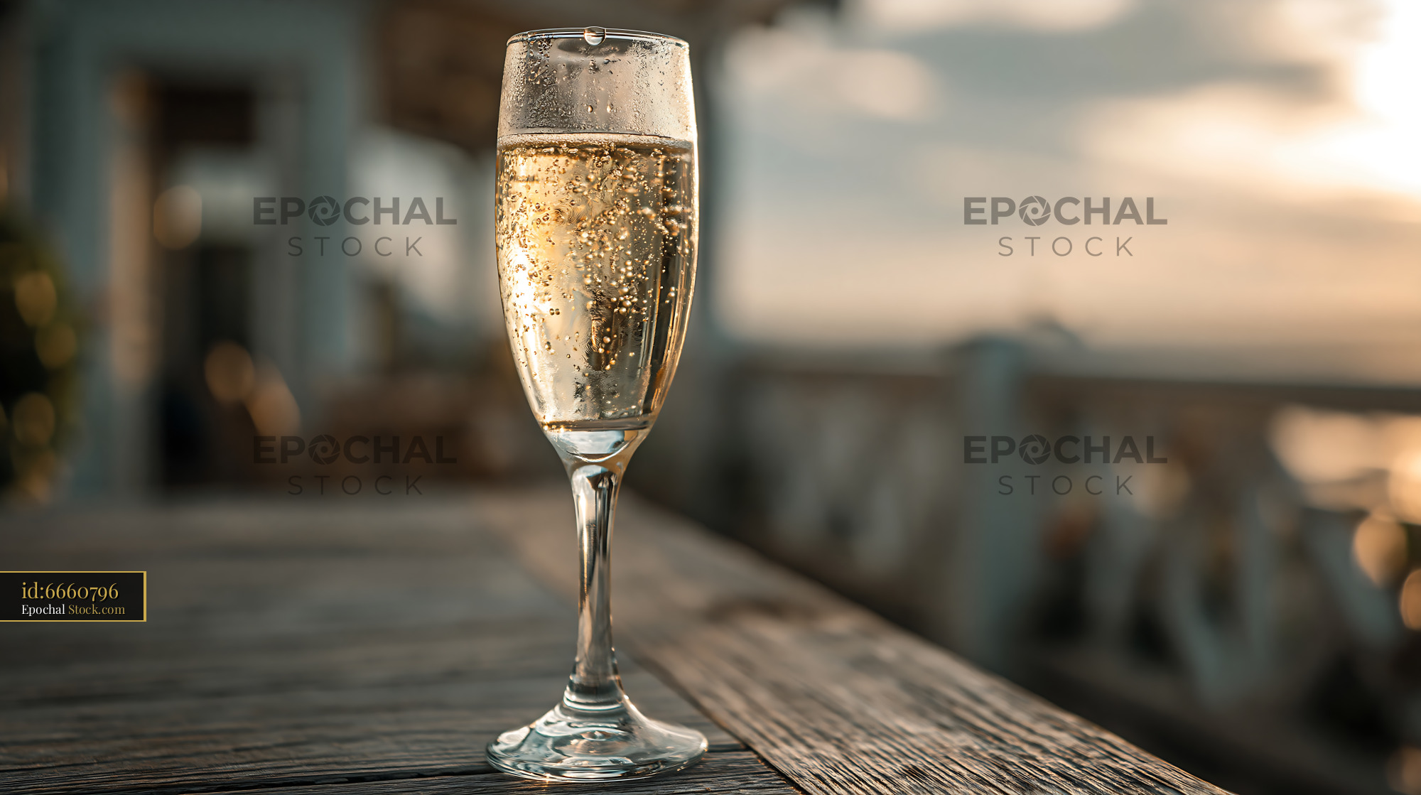 Refreshing sparkling lemonade in a glass flute at sunset - stock photo