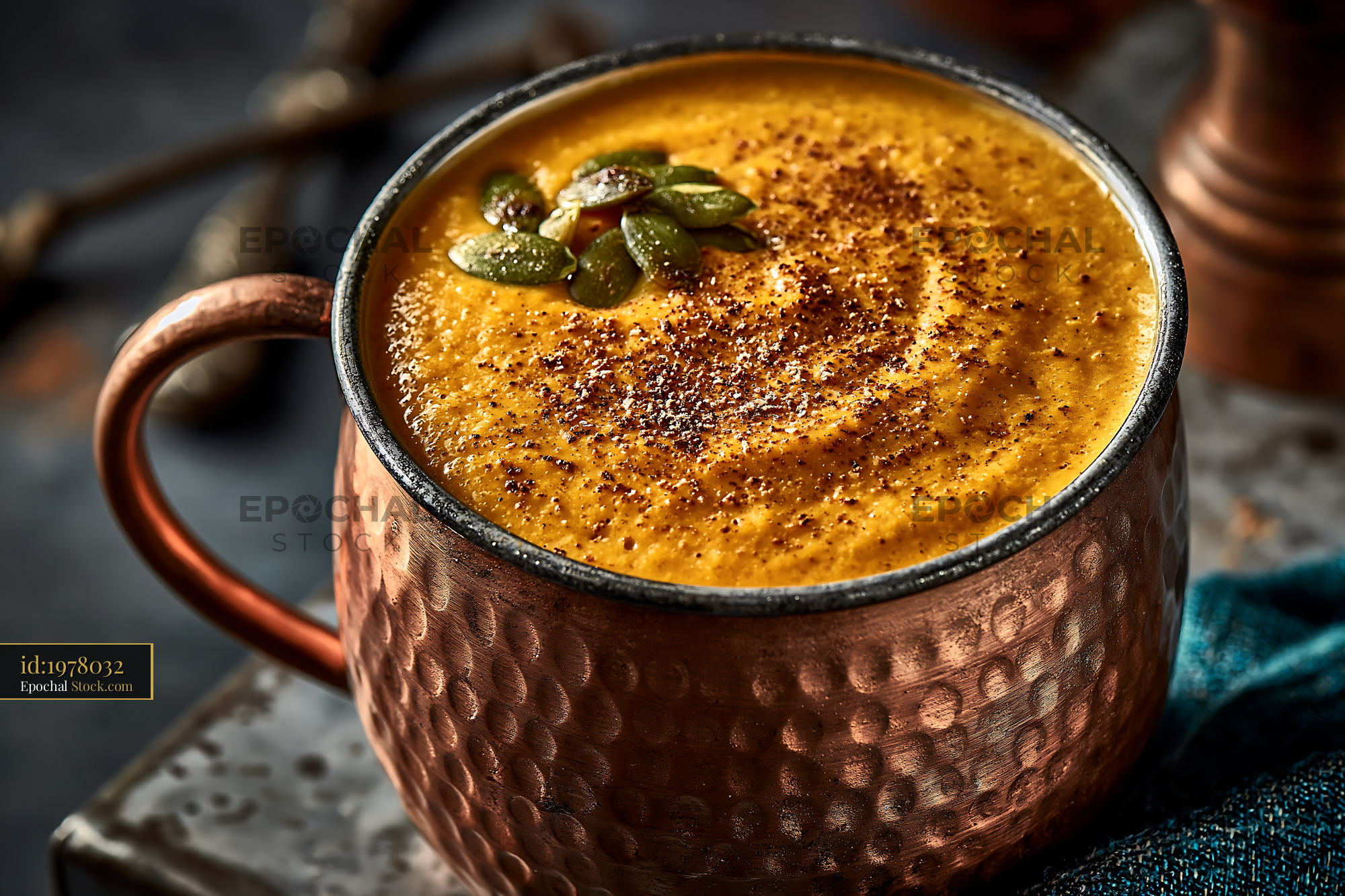 Creamy kabocha pumpkin smoothie in a hammered copper mug - stock photo