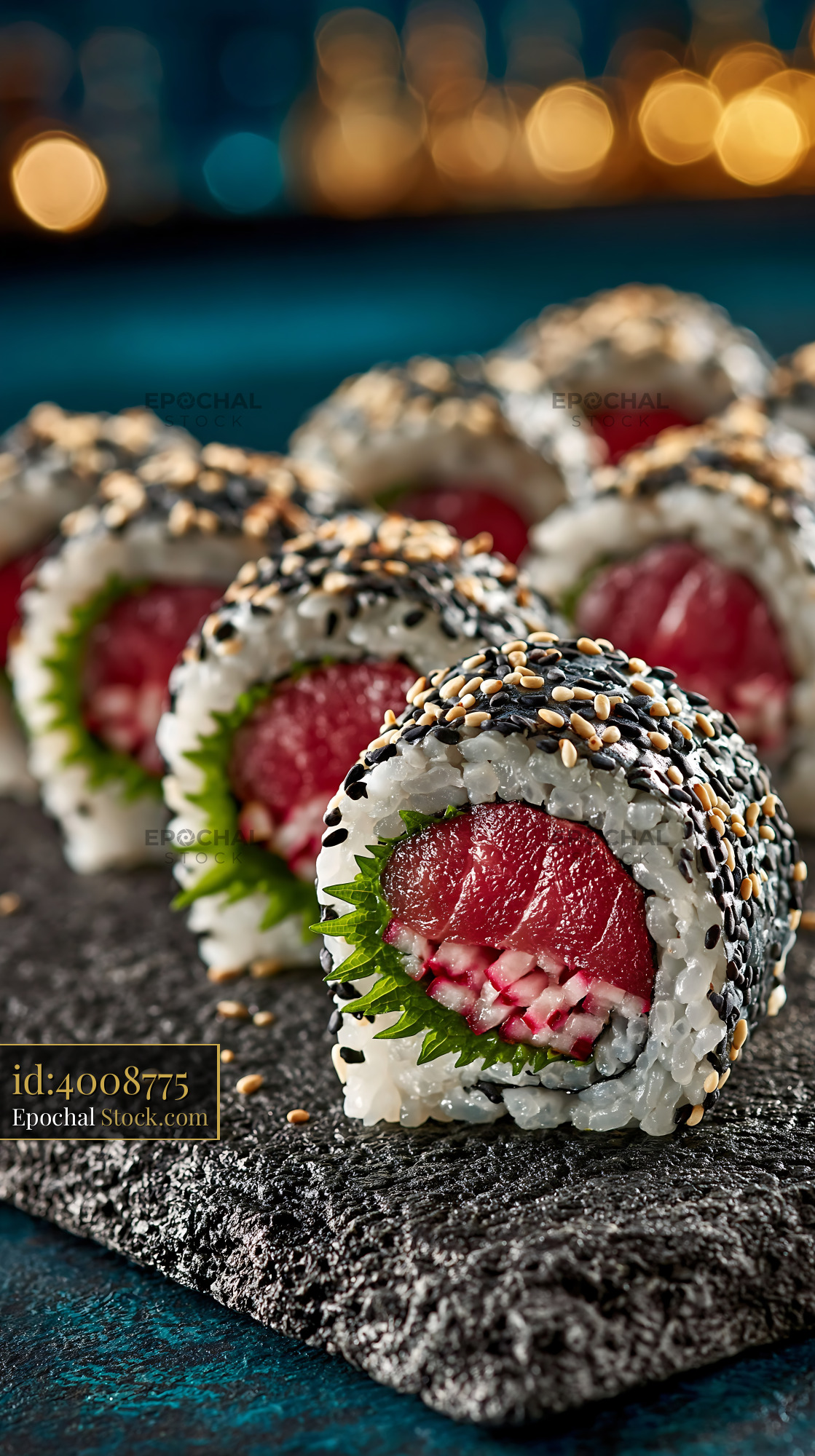 Fresh shiso leaf uramaki sushi with tuna and sesame on dark stone - stock photo