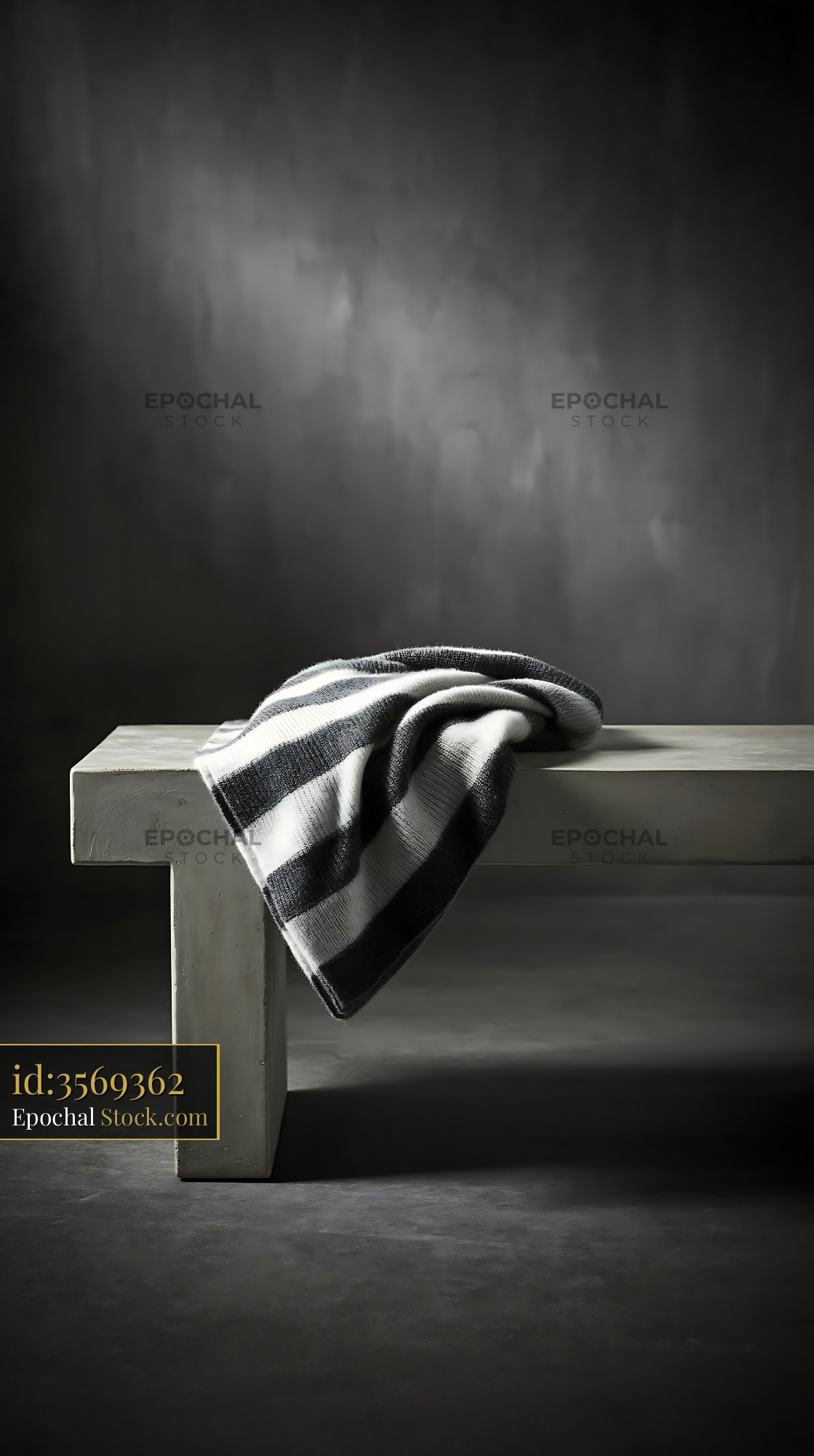 Striped throw on bench in a minimalist dark interior - stock photo