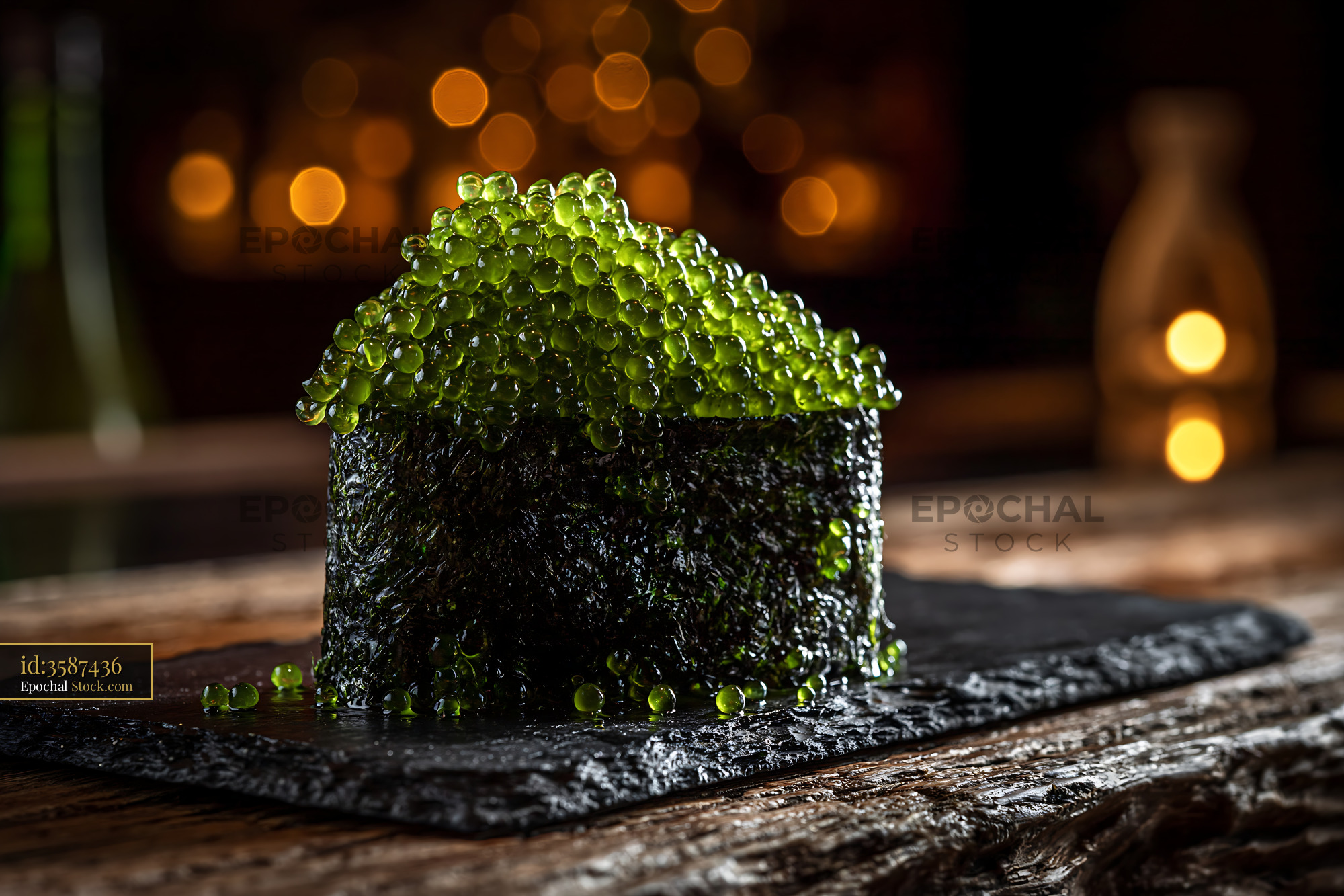 Umi budo sushi gunkanmaki with green sea grapes on slate plate - stock photo