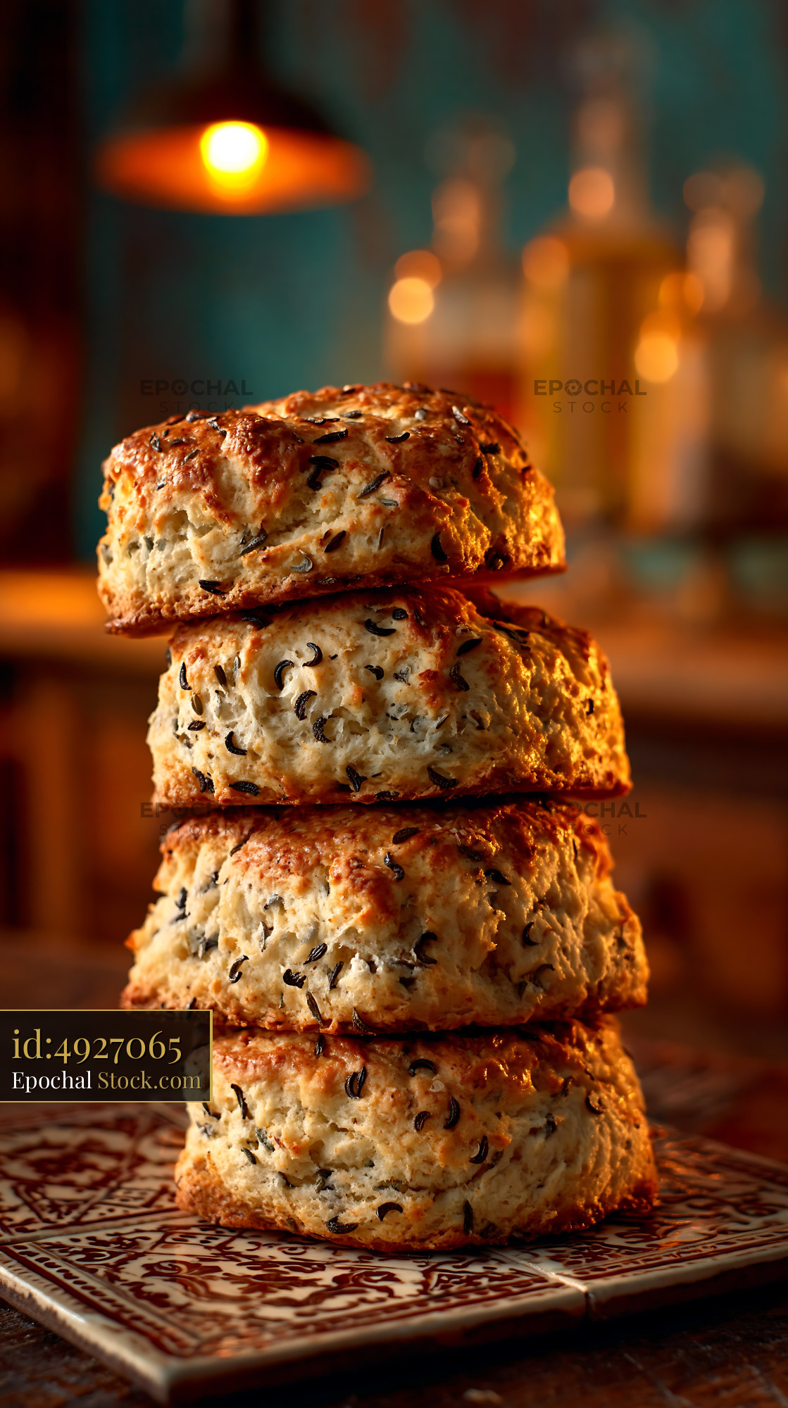 Stack of golden caraway seed biscuits on a rustic kitchen counter - stock photo