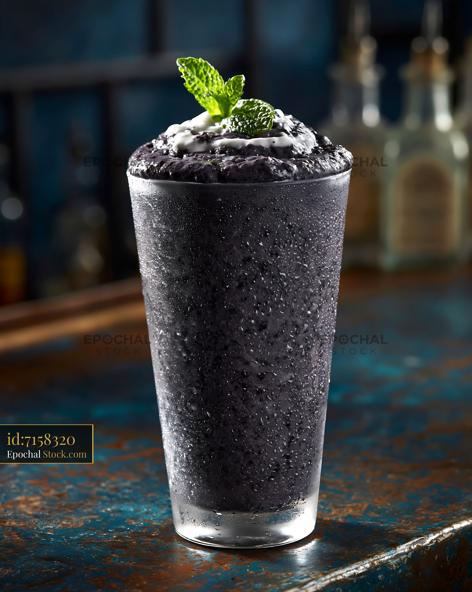 Refreshing black bean smoothie with mint and cream in a frosted glass - stock photo