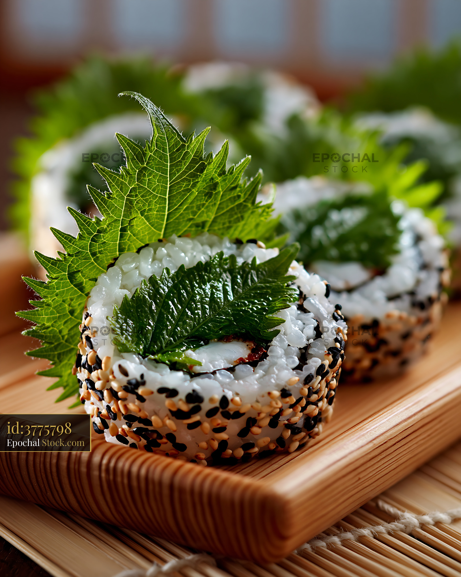 Gourmet uramaki sushi rolls with fresh shiso leaves and sesame seeds - stock photo