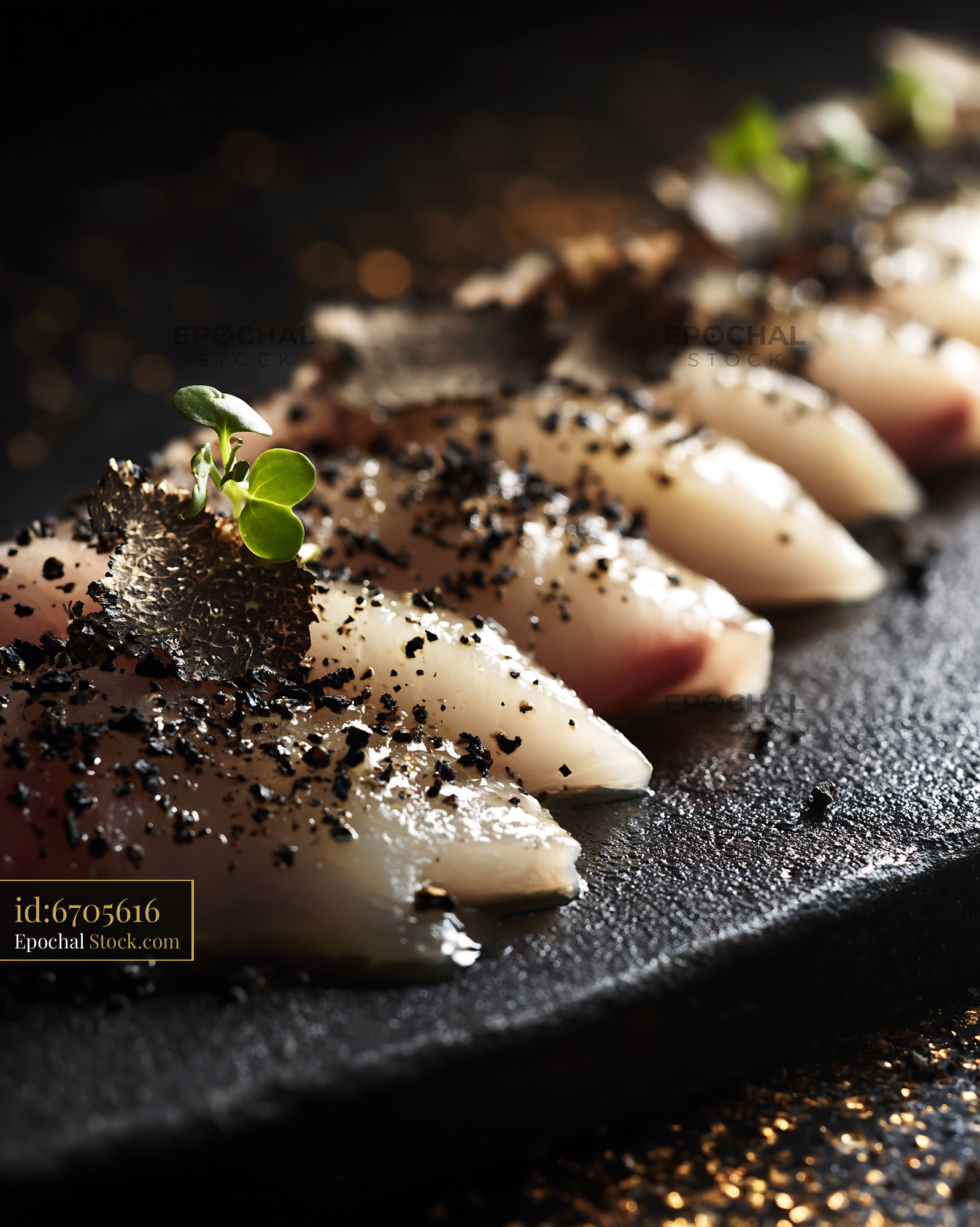 Fresh yellowtail sushi slices topped with black truffle and microgreen - stock photo