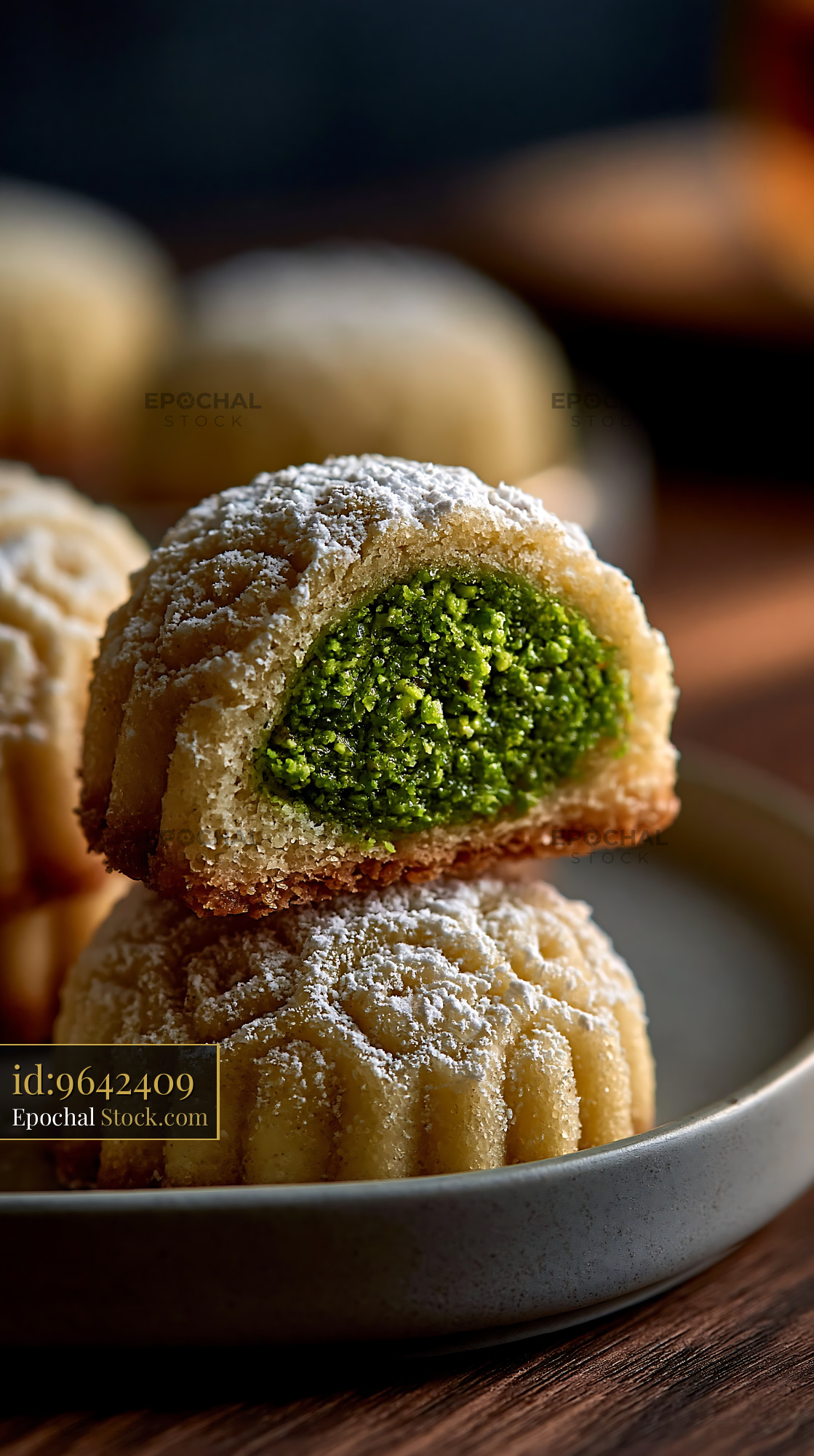Pistachio maamoul biscuits dusted with powdered sugar on a plate - stock photo