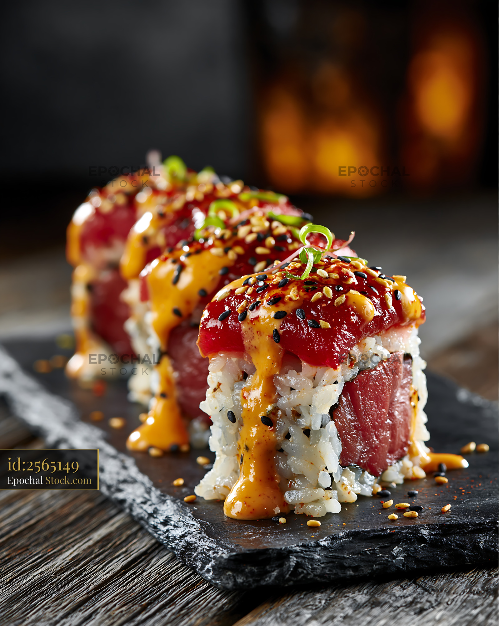 Fresh sriracha mayo tuna sushi rolls served on a slate platter - stock photo