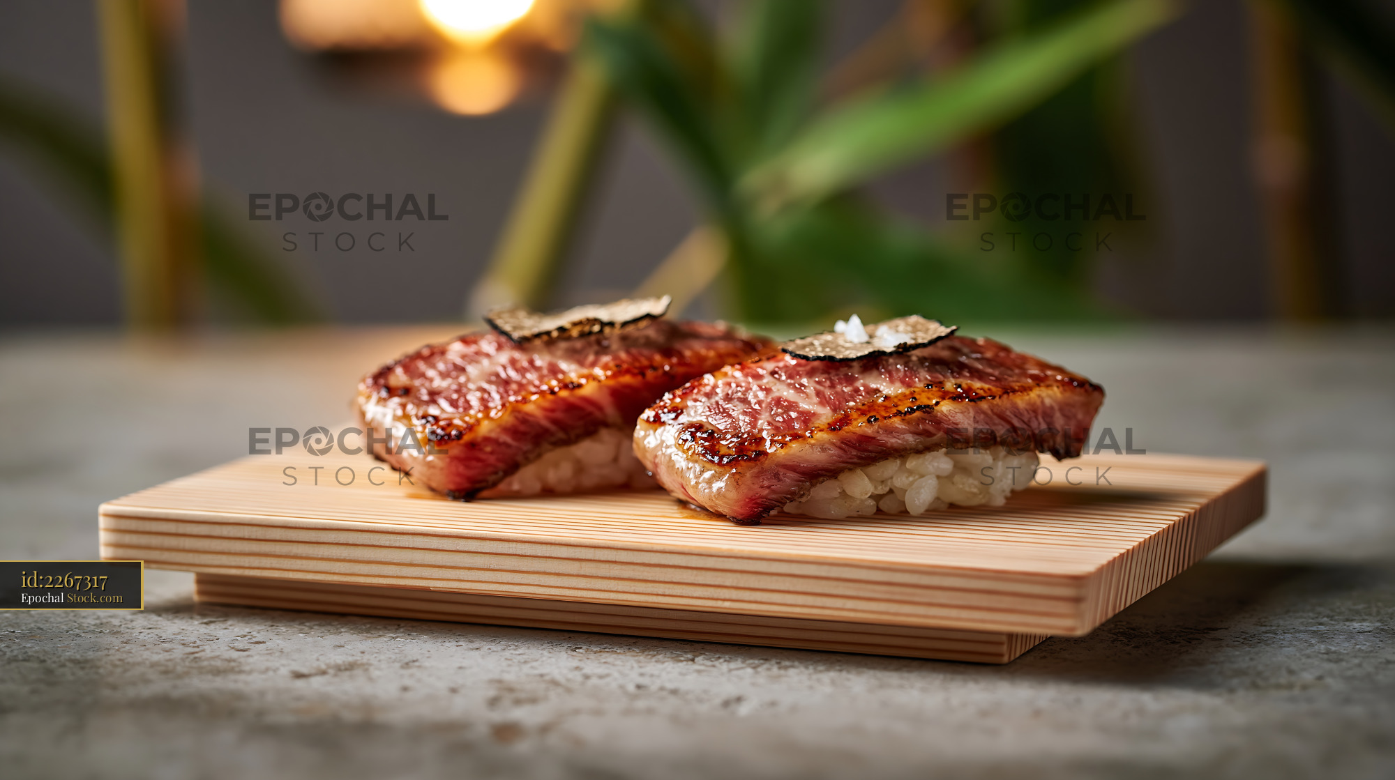 Aburi wagyu sushi topped with truffle and sea salt on wooden board - stock photo