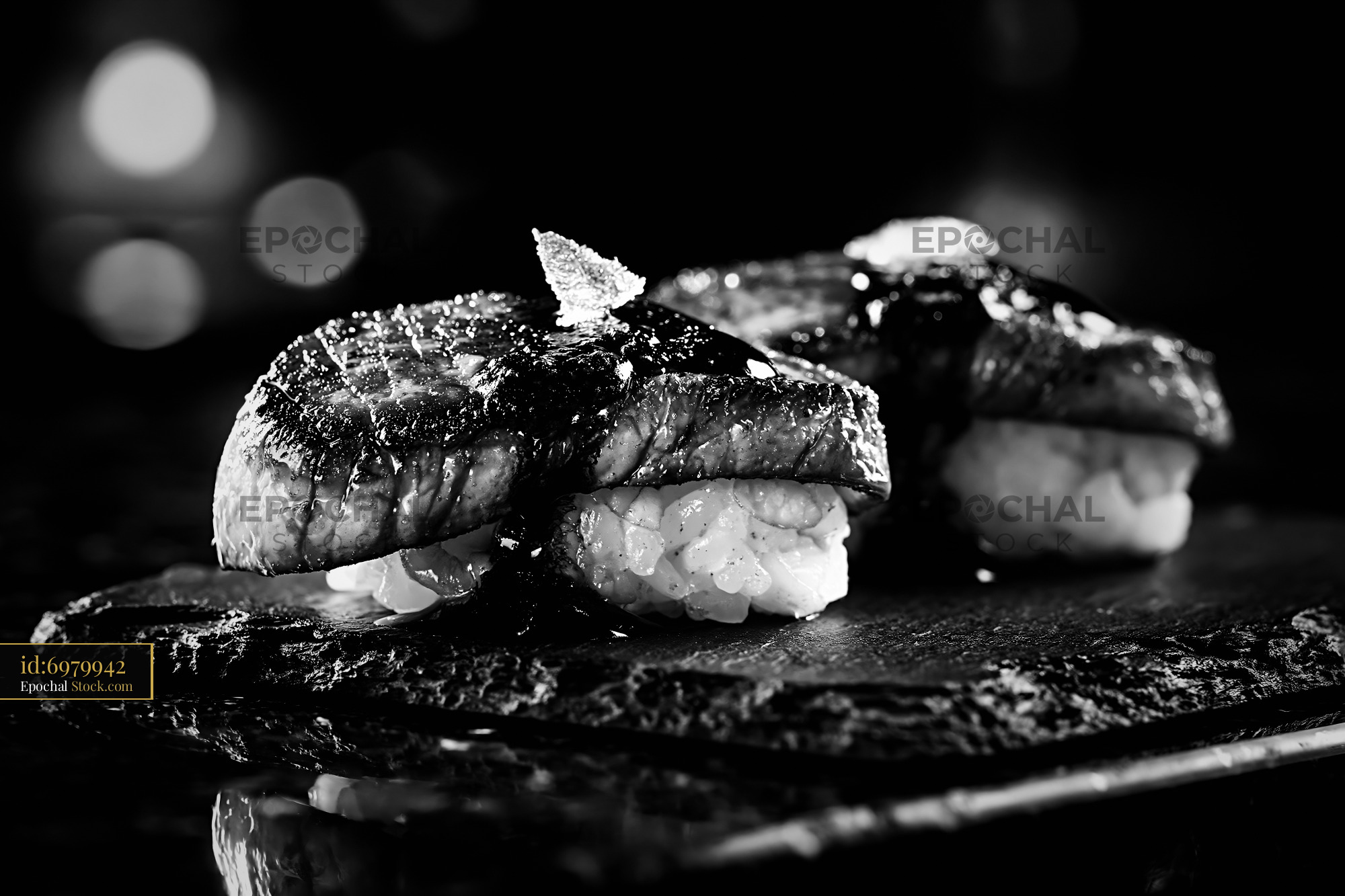 Gourmet foie gras nigiri sushi on a dark slate plate - stock photo