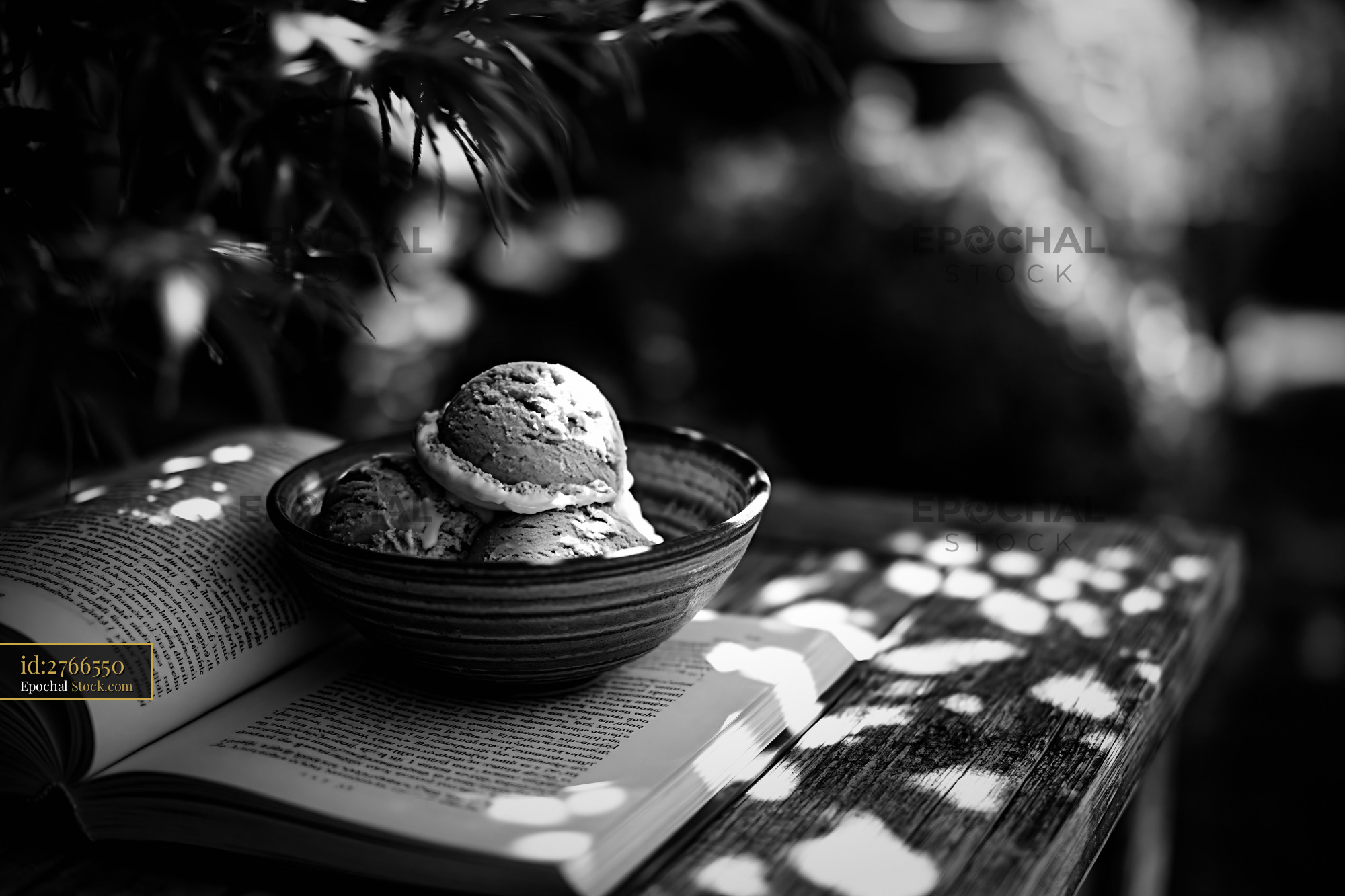 Chartreuse ice cream scoops in a ceramic bowl on an open book - stock photo