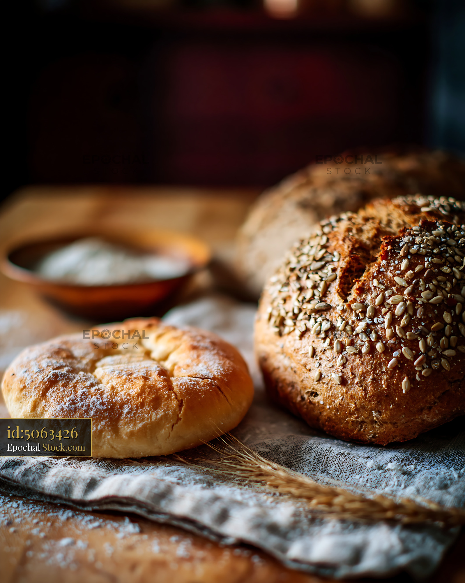 Navajo frybread and seeded German bread on a rustic wooden table - stock photo
