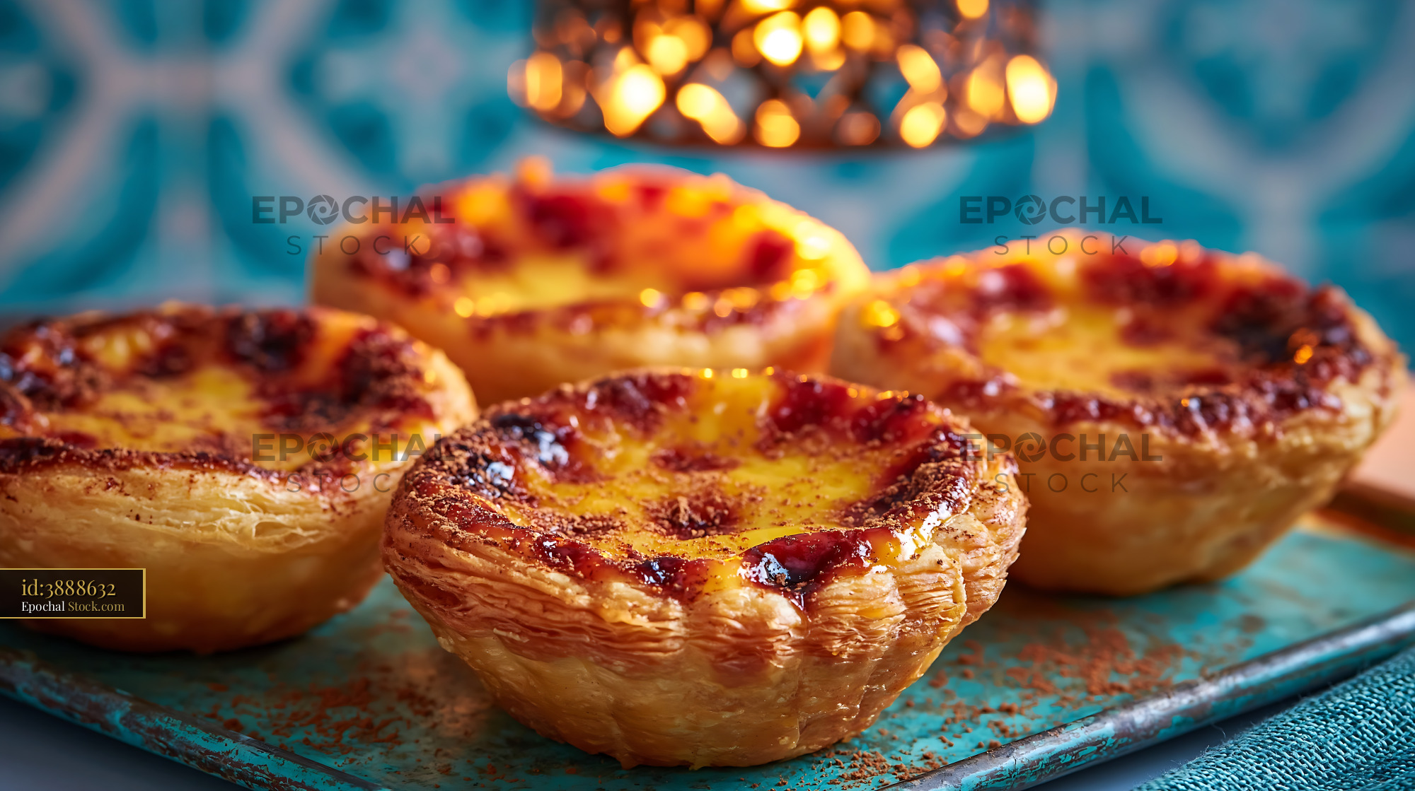 Traditional Portuguese custard tarts on a blue tray with azulejo tiles - stock photo