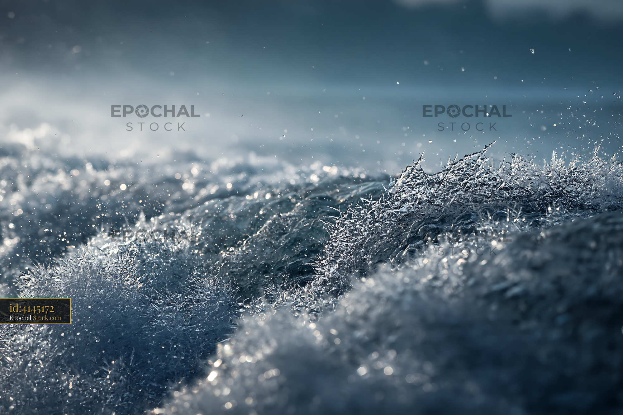 Frozen sea spray and ice crystals on waves during winter storm at dusk - stock photo