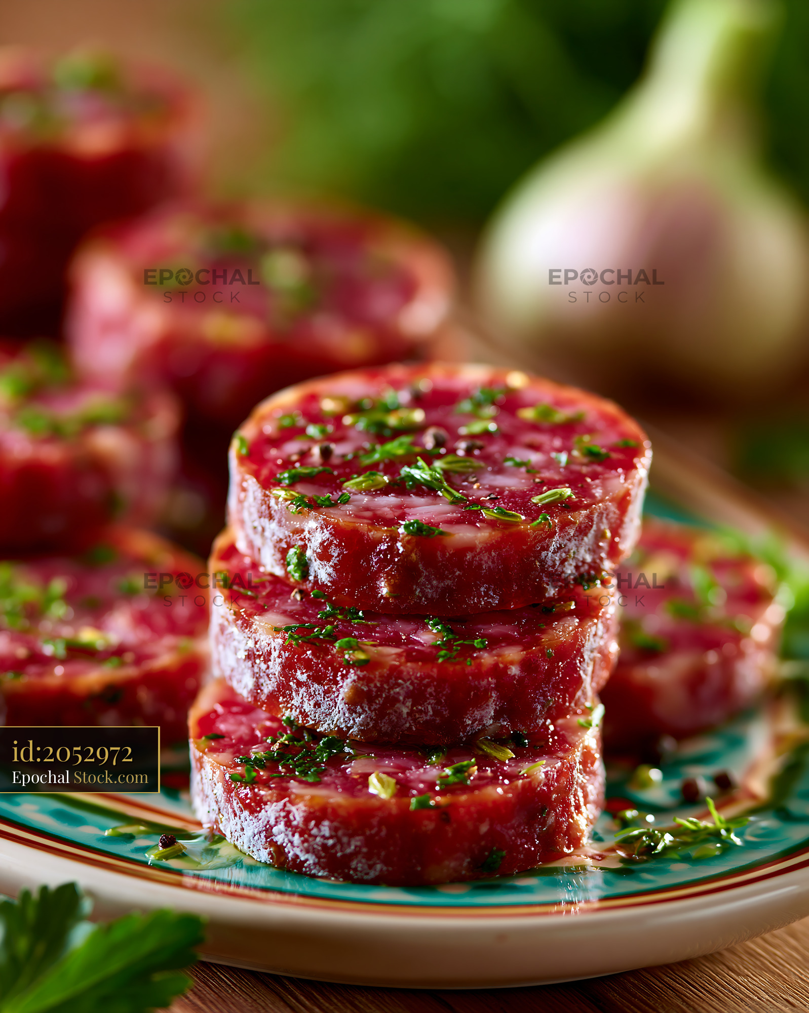 Slices of culatello di zibello meat with herbs on a plate