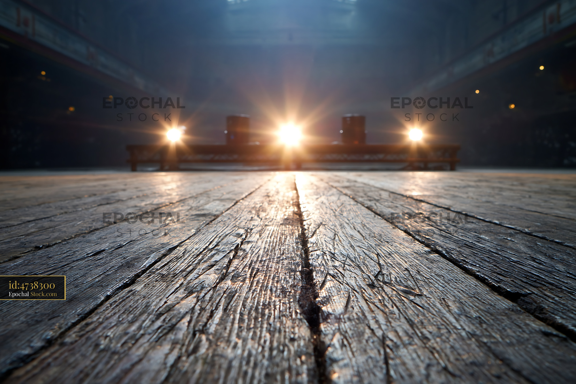 Empty wooden stage with bright flares from stage lights in a dark hall - stock photo