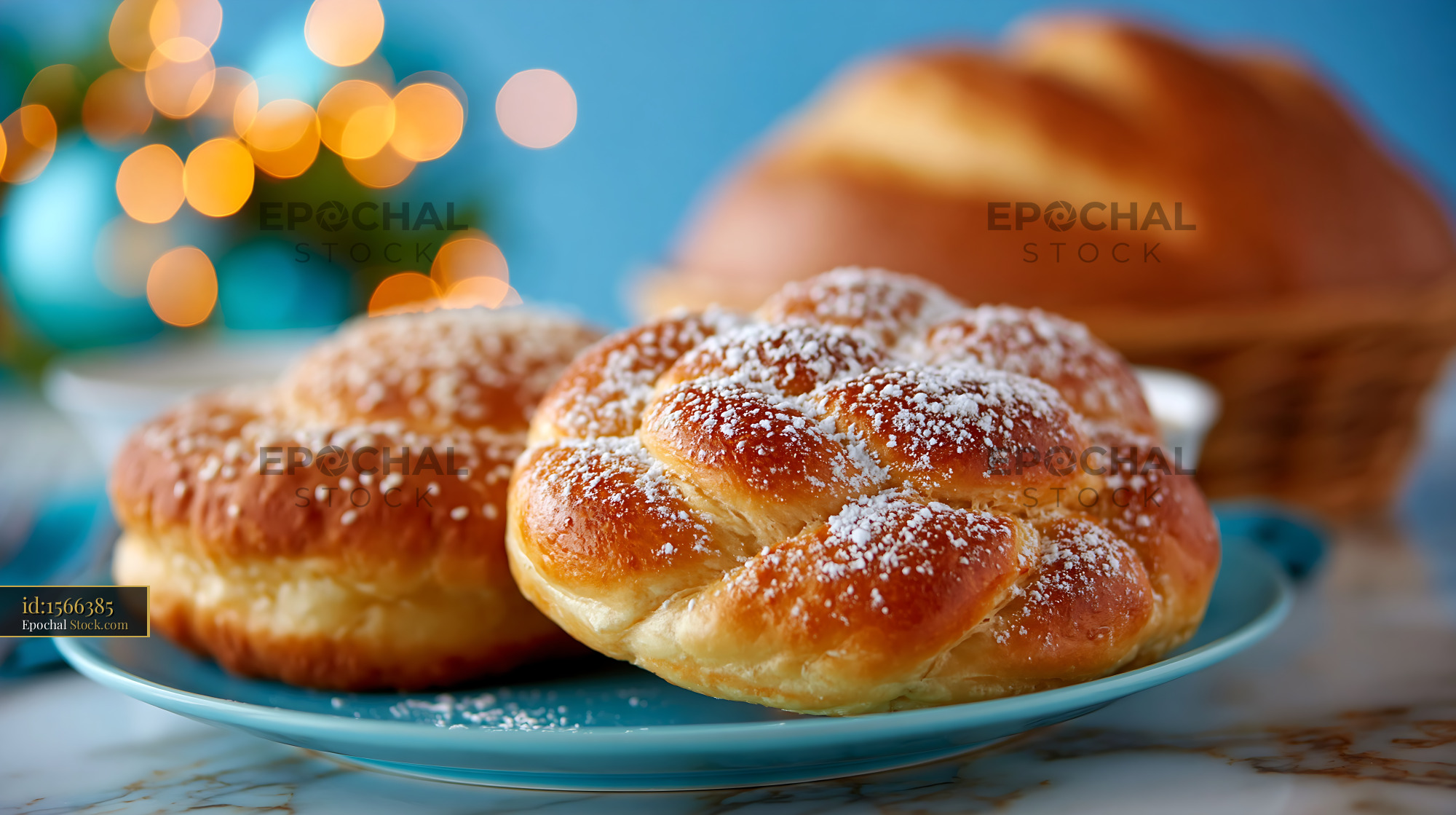 German braided sweet bread with powdered sugar on a blue plate - stock photo