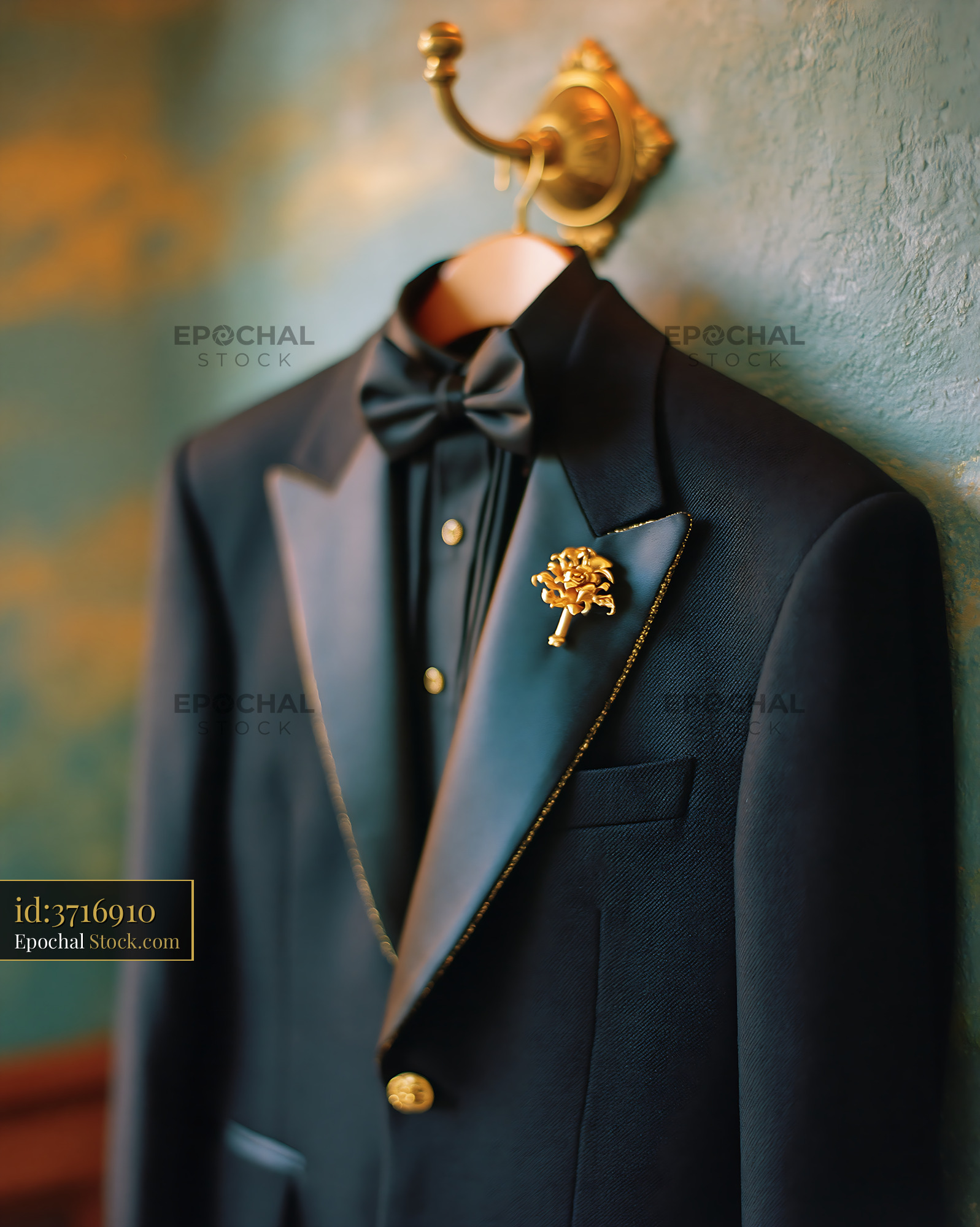 Elegant black tuxedo jacket on a dressing room hook with gold accents - stock photo