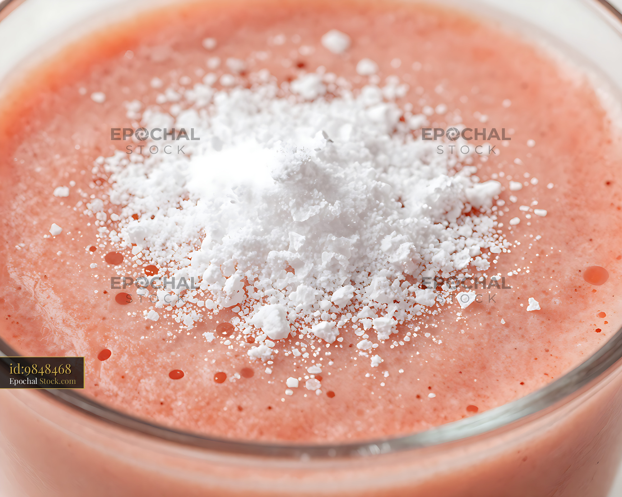 Acerola Sunrise smoothie with nutrient powder topping in a glass - stock photo