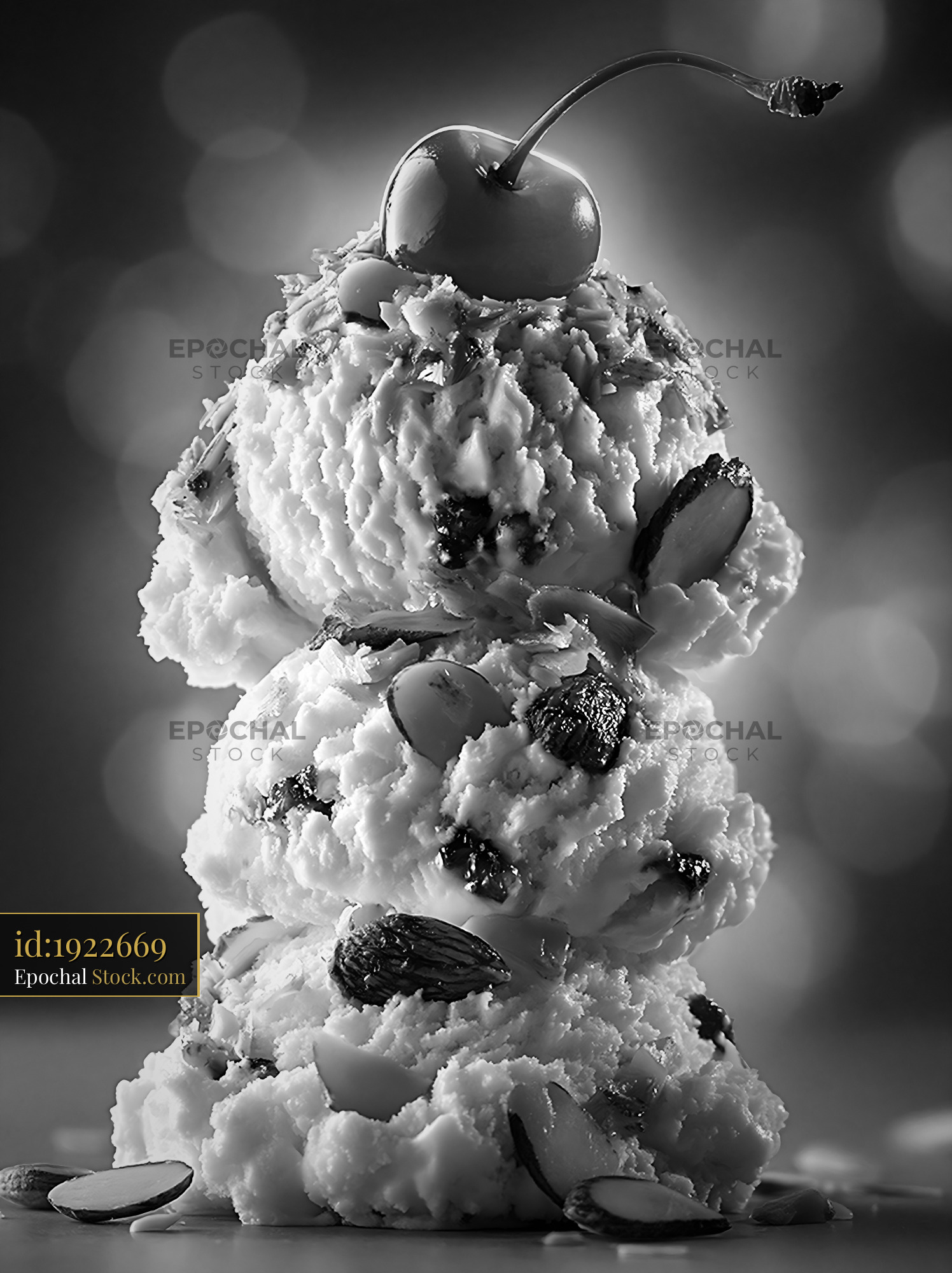 Three scoops of amaretto ice cream with almonds and a cherry - stock photo