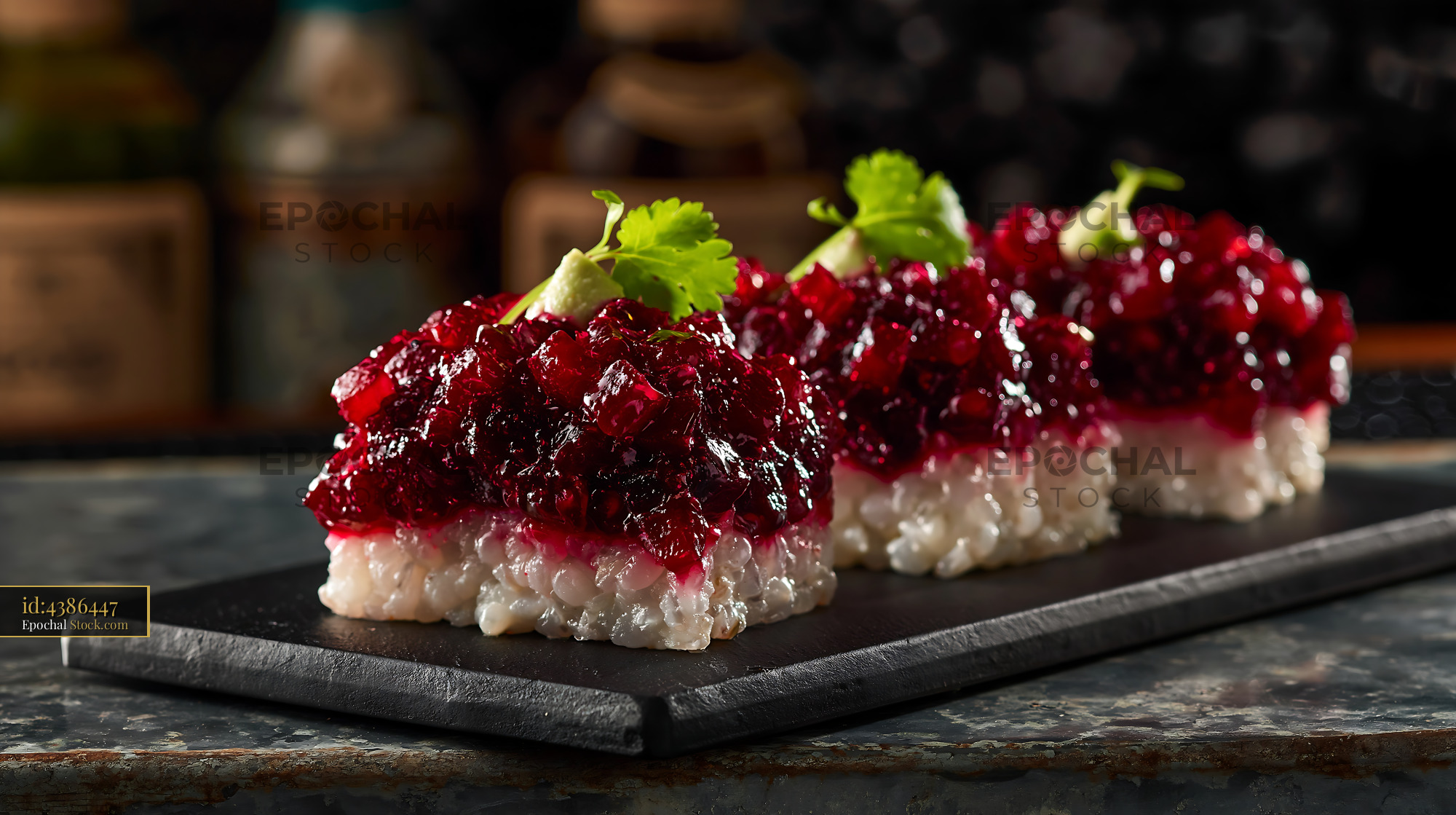 Gourmet beet tartare sushi appetizers on a dark slate board - stock photo