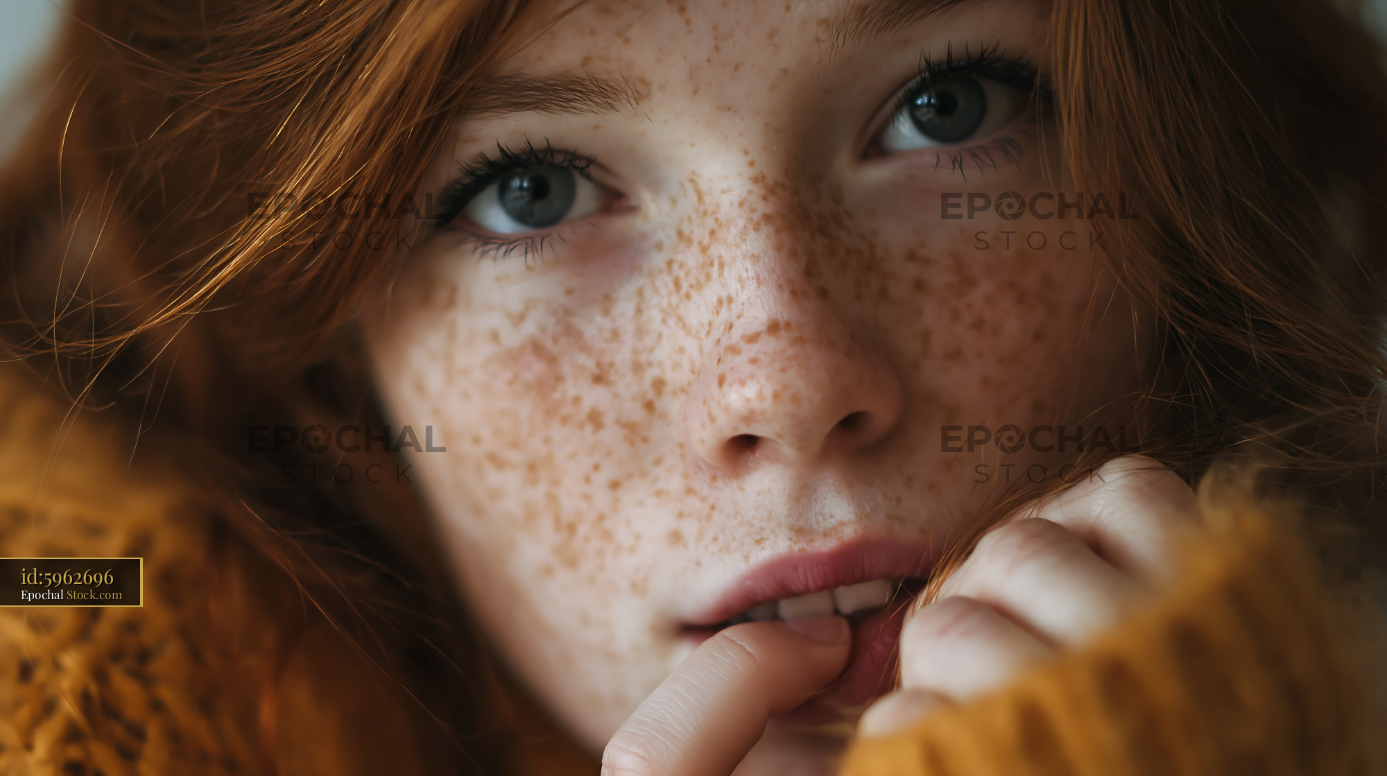 Young redhead girl with freckles looking nervous and biting her lip - stock photo