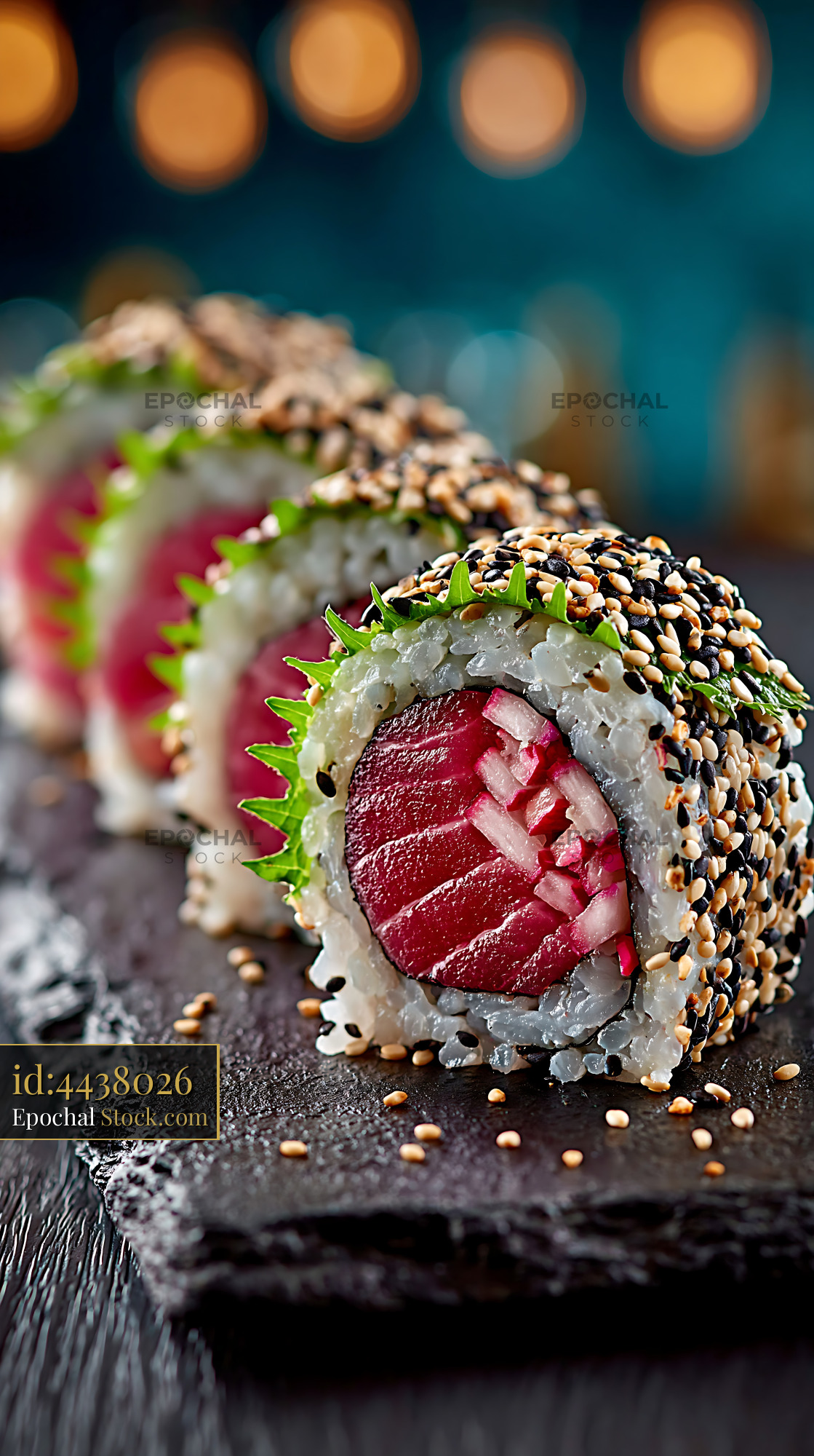 Yuzu kosho yellowtail sushi rolls with sesame seeds on slate board - stock photo