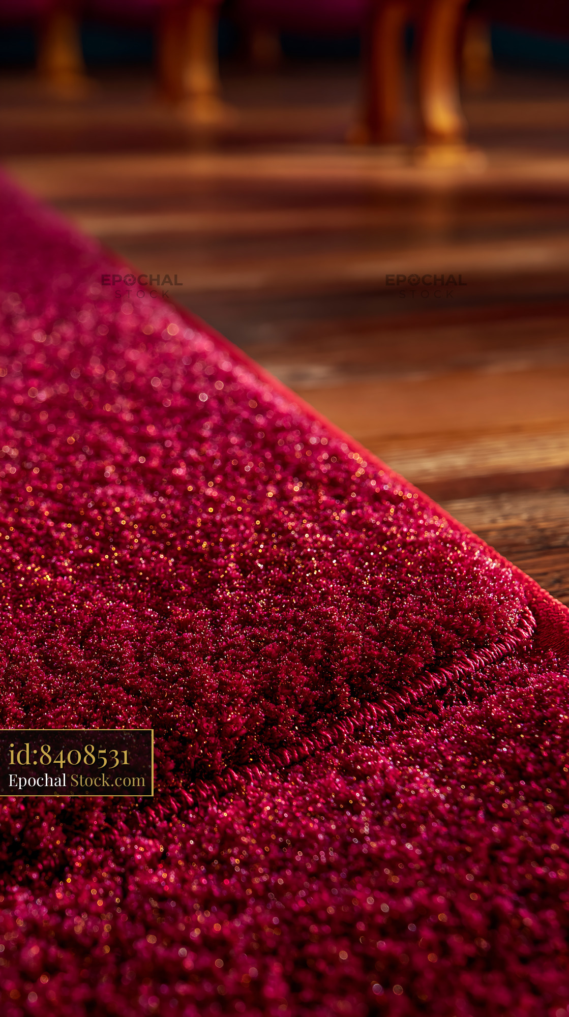 Plush red carpet on wooden floor with stage lights flare - stock photo