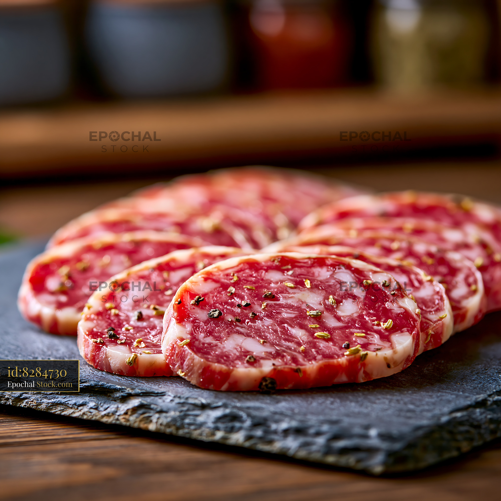 Slices of authentic finocchiona igp meat on a dark slate board - stock photo