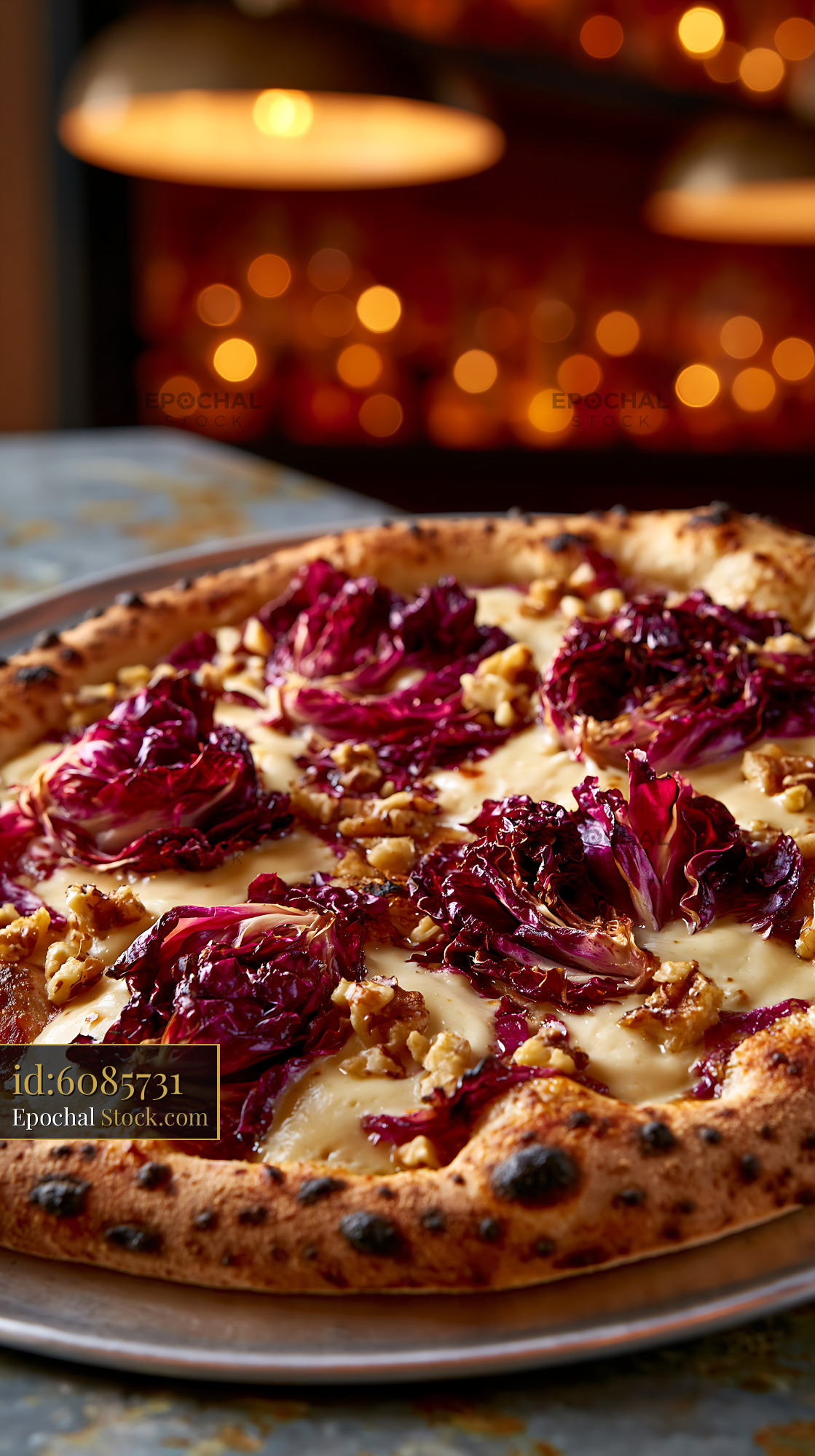 Gourmet radicchio taleggio pizza with walnuts in a restaurant - stock photo