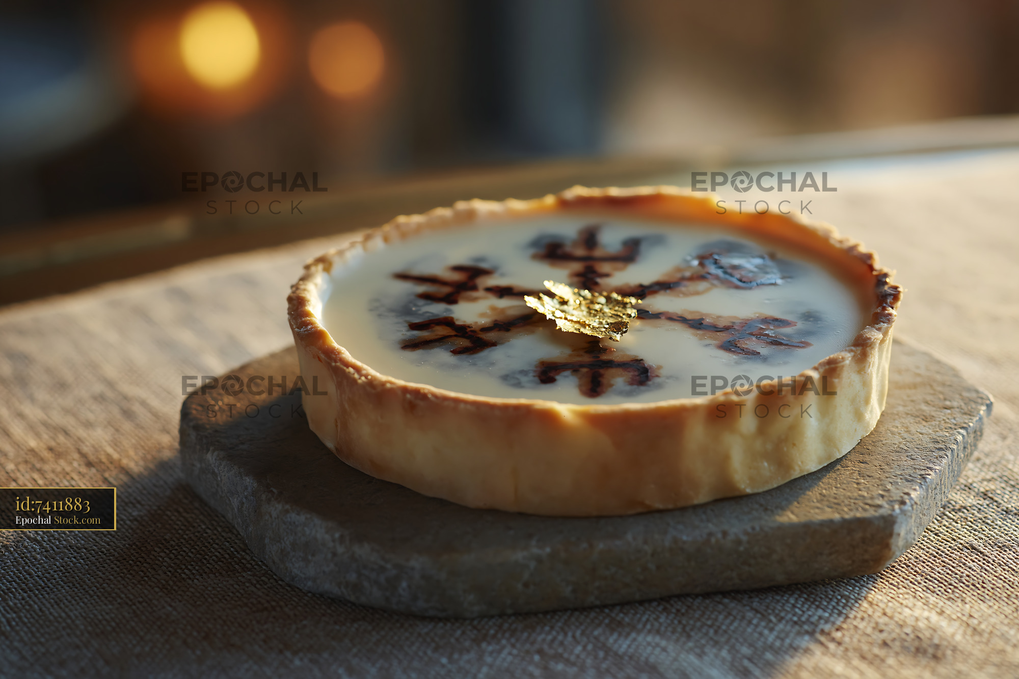 Gourmet tart with Nordic symbol and edible gold leaf on rustic stone - stock photo